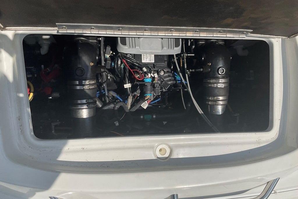 Engine compartment of a 2015 Crownline 236 SC boat, showcasing mechanical components.