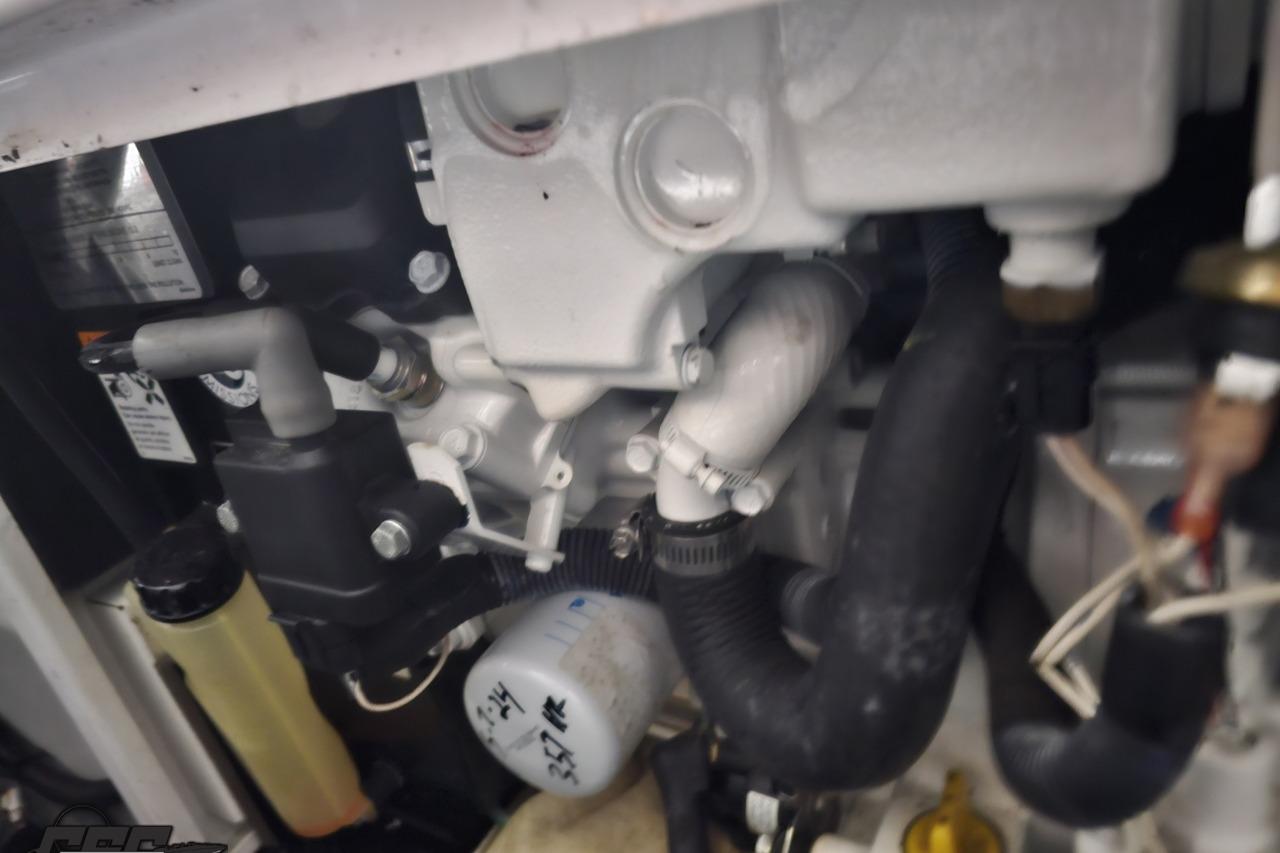 Engine components of a 2008 Baja 335 Performance boat, featuring hoses and filters.