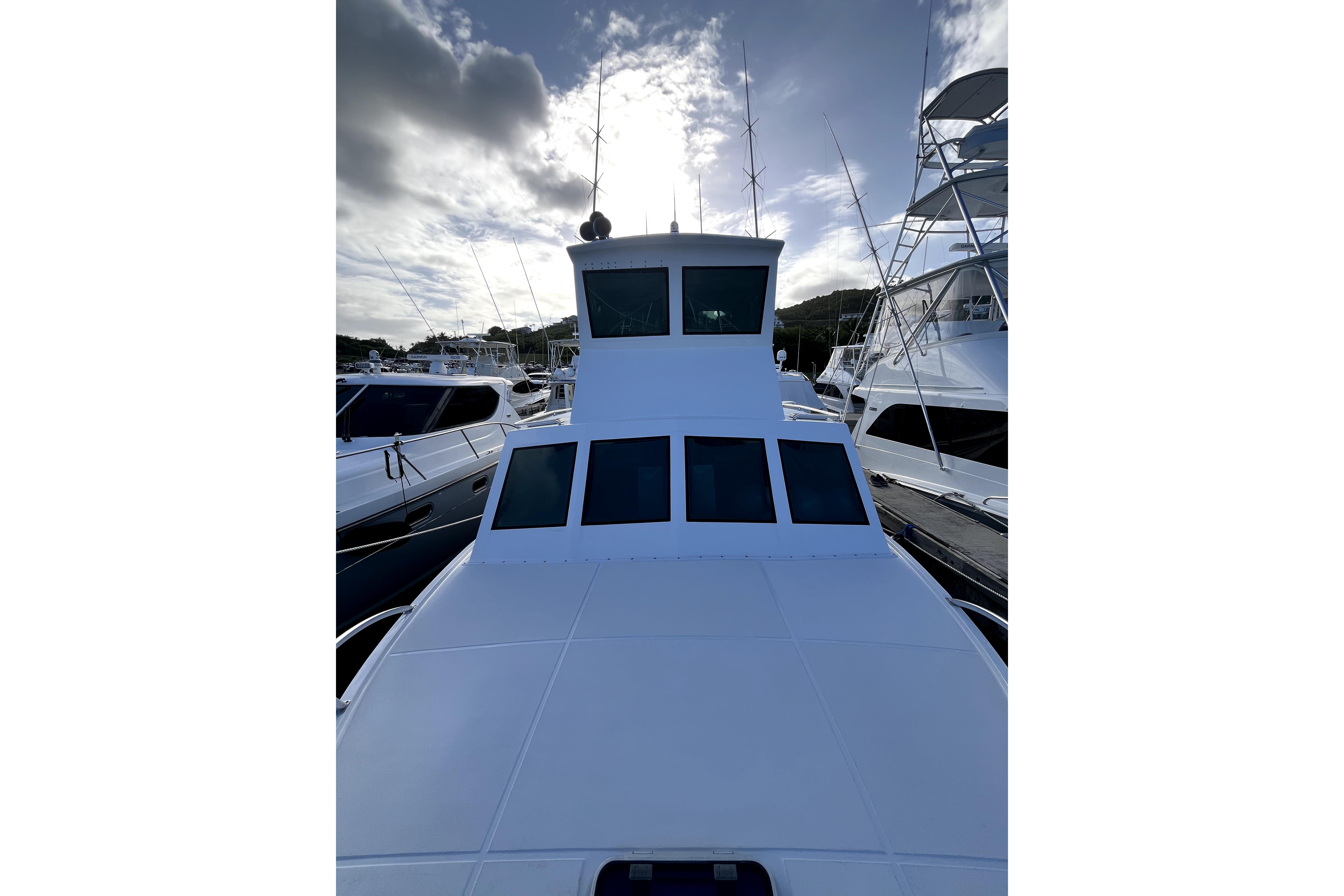 1982 Torres Boat Mfg 43 docked, showcasing sleek design and spacious deck under cloudy sky.