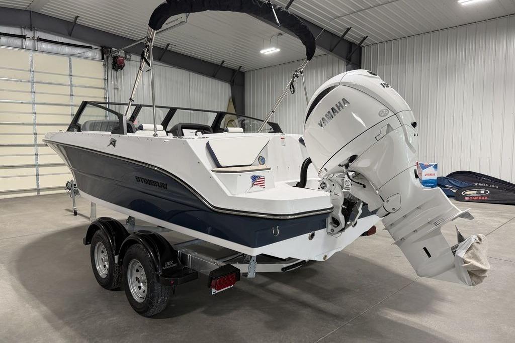 2027 Stingray 20 SBX boat with Yamaha engine in a garage setting.