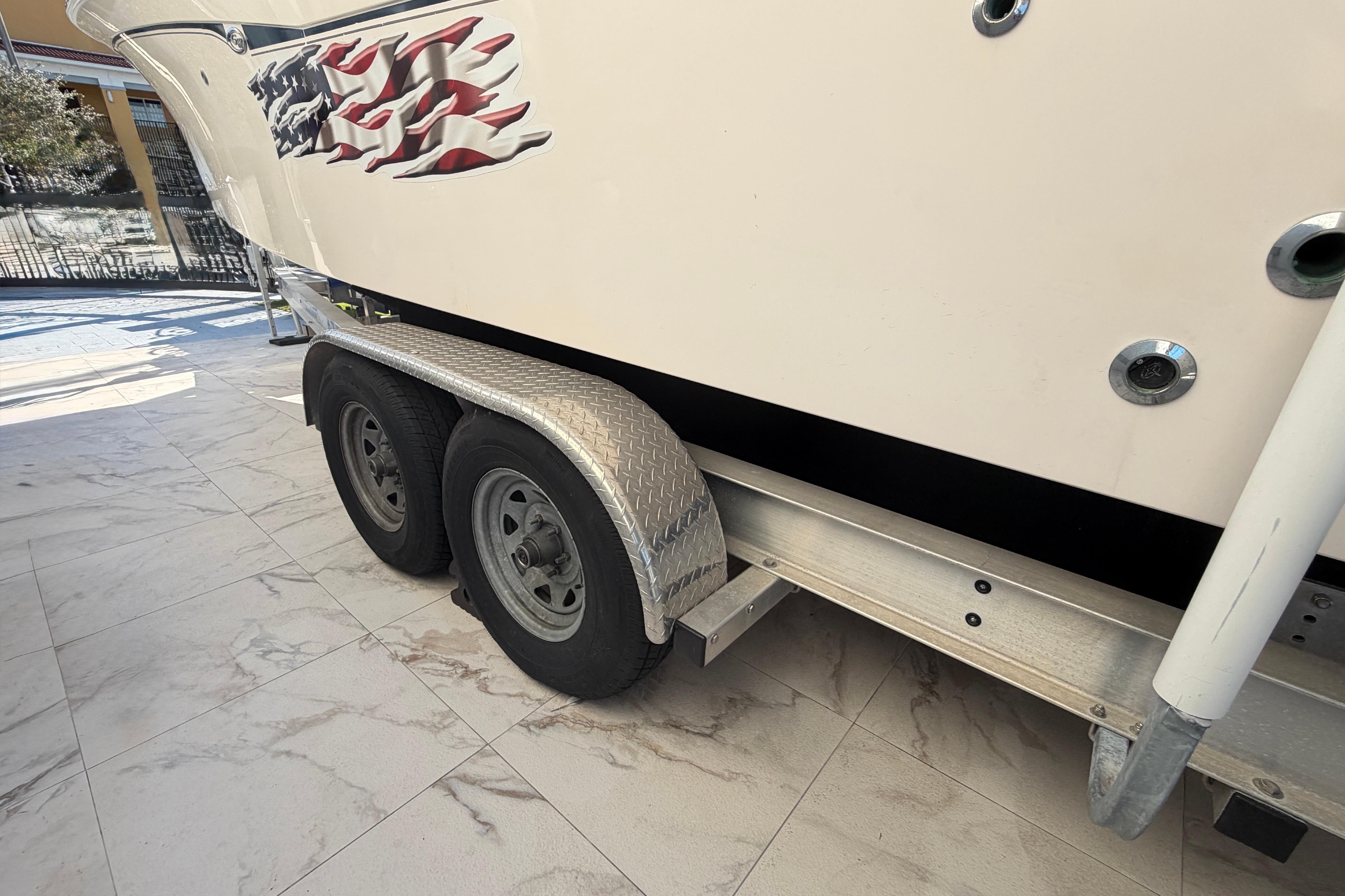 2004 Grady White 273 boat on trailer with American flag decal.