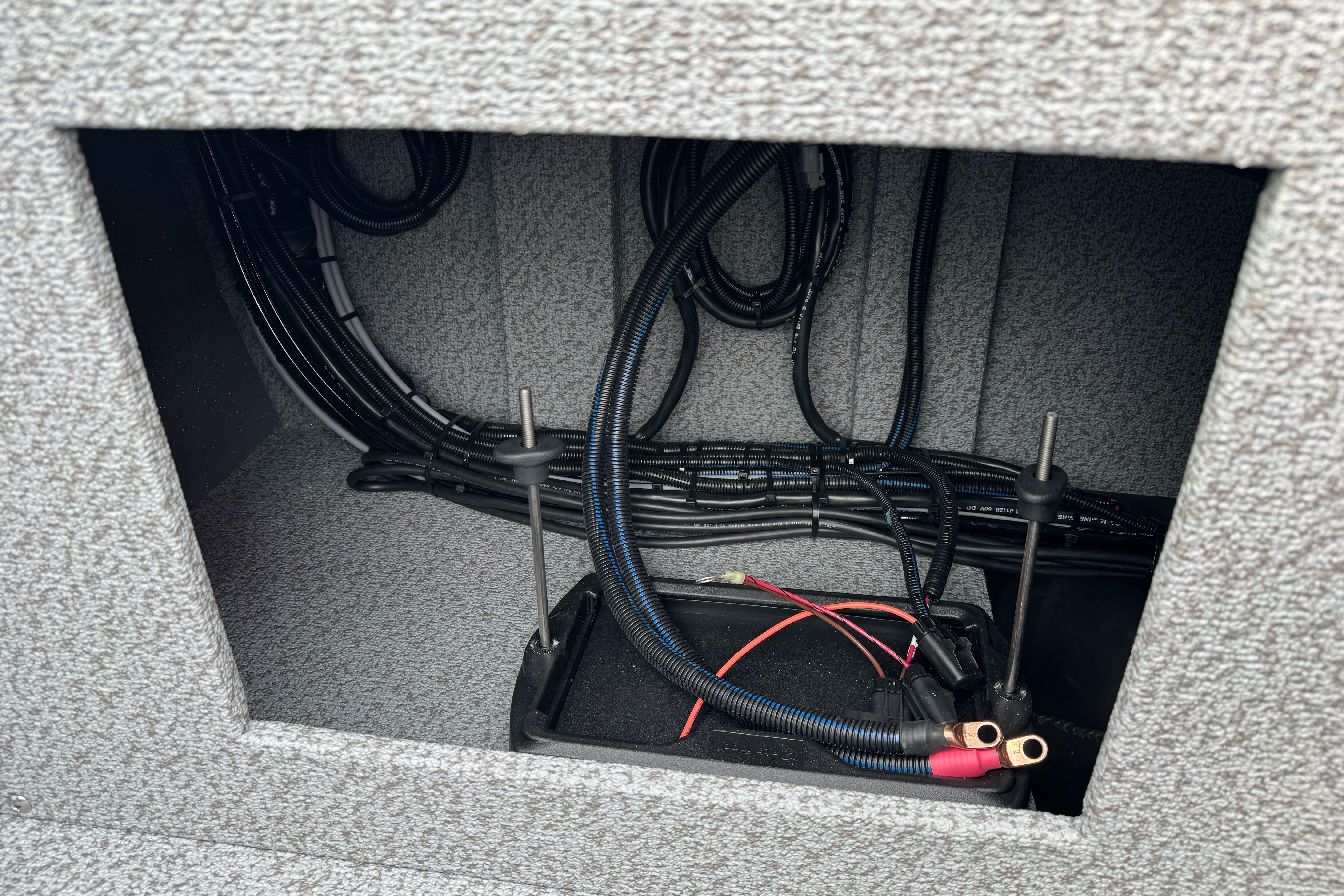 Interior wiring of 2026 Lund 185 Heavy Gauge boat, showcasing cables and battery connections.