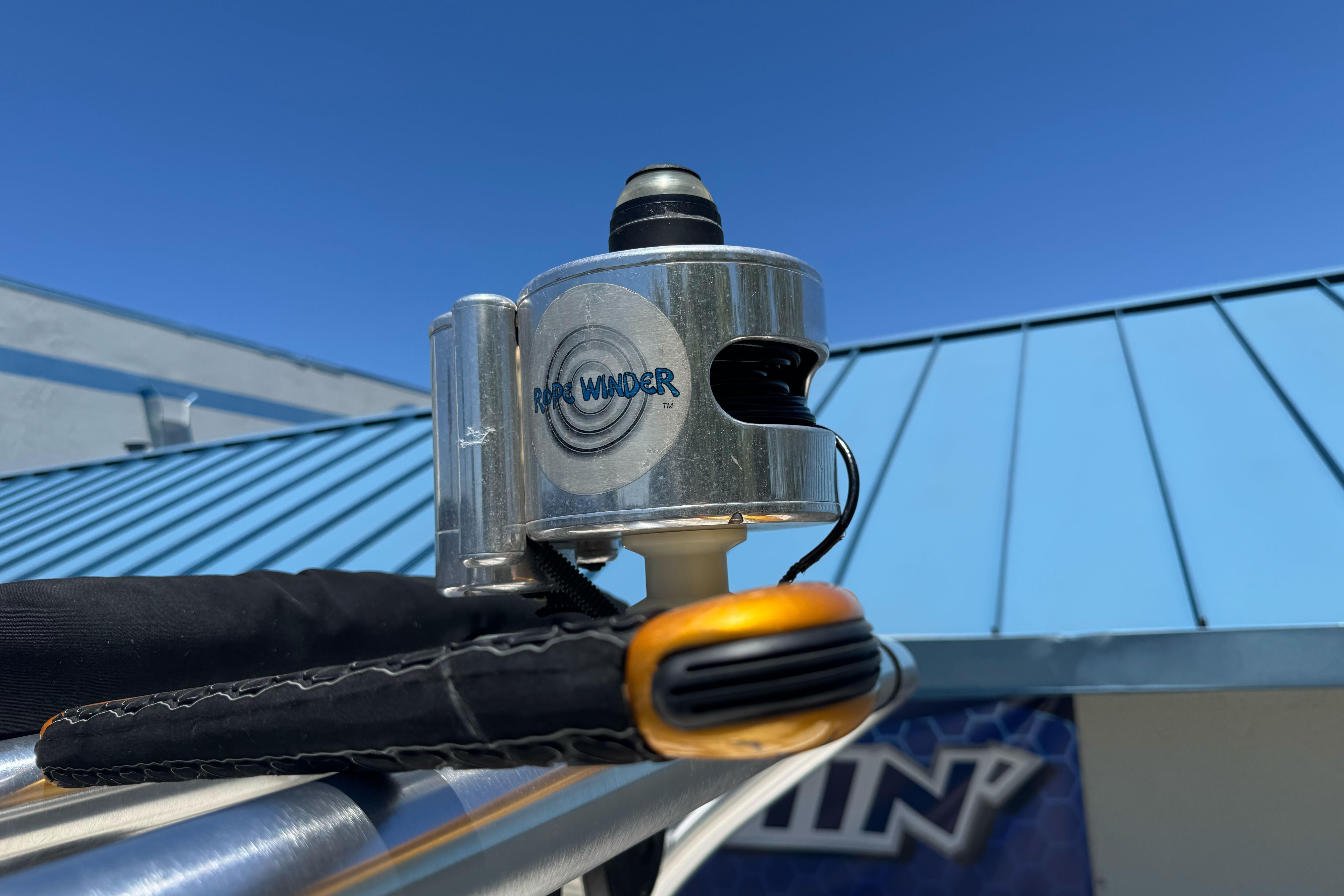 Rope winder device on a 2007 Sea Ray SLX 250 boat against a clear blue sky.