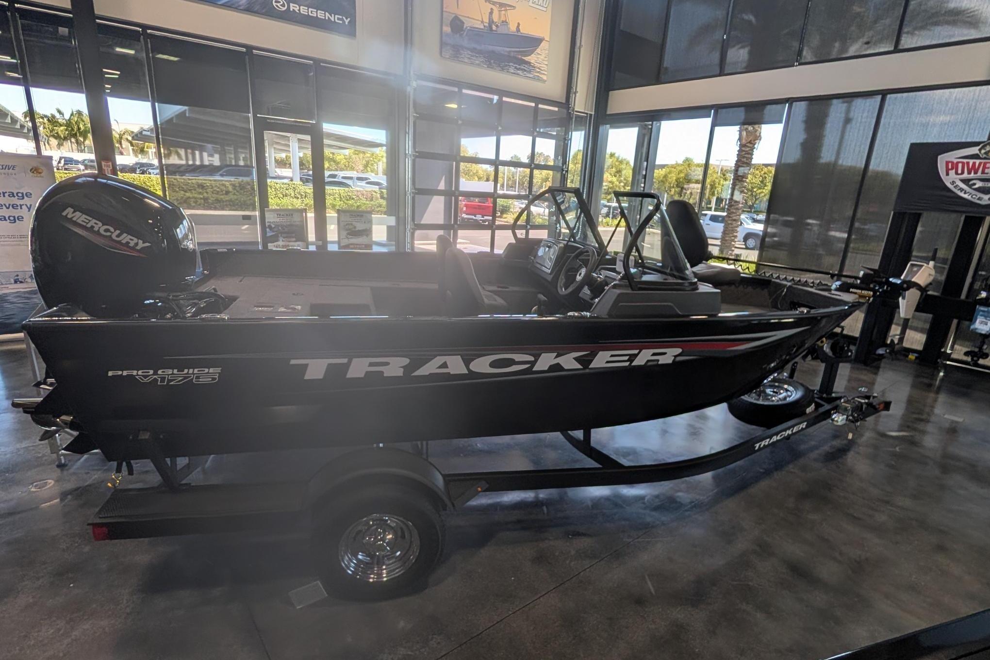 2026 Tracker Pro Guide V-175 Combo boat displayed indoors with Mercury engine.