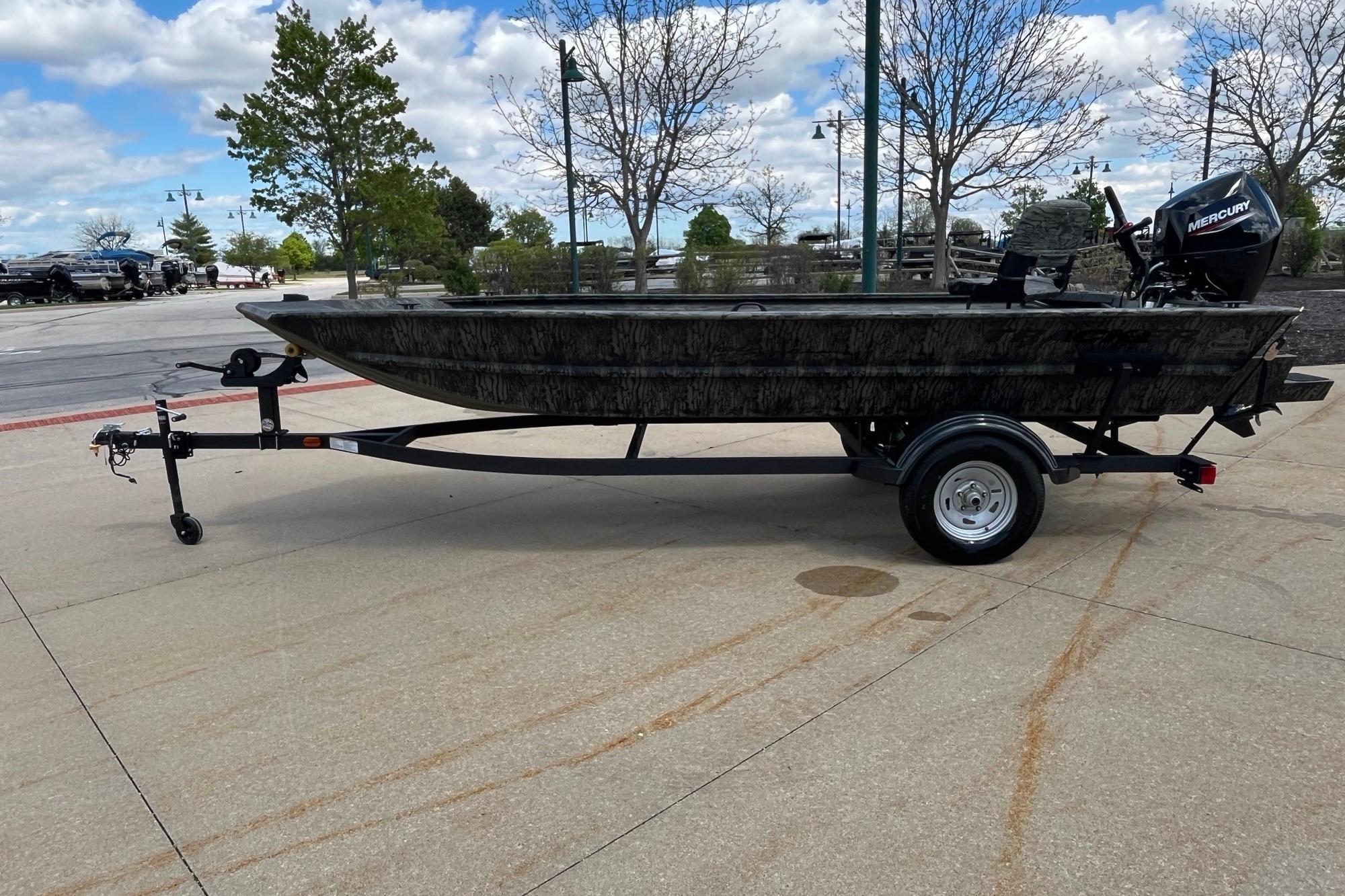 2026 Tracker Grizzly 1654 T Sportsman boat on trailer, outdoors under cloudy sky.