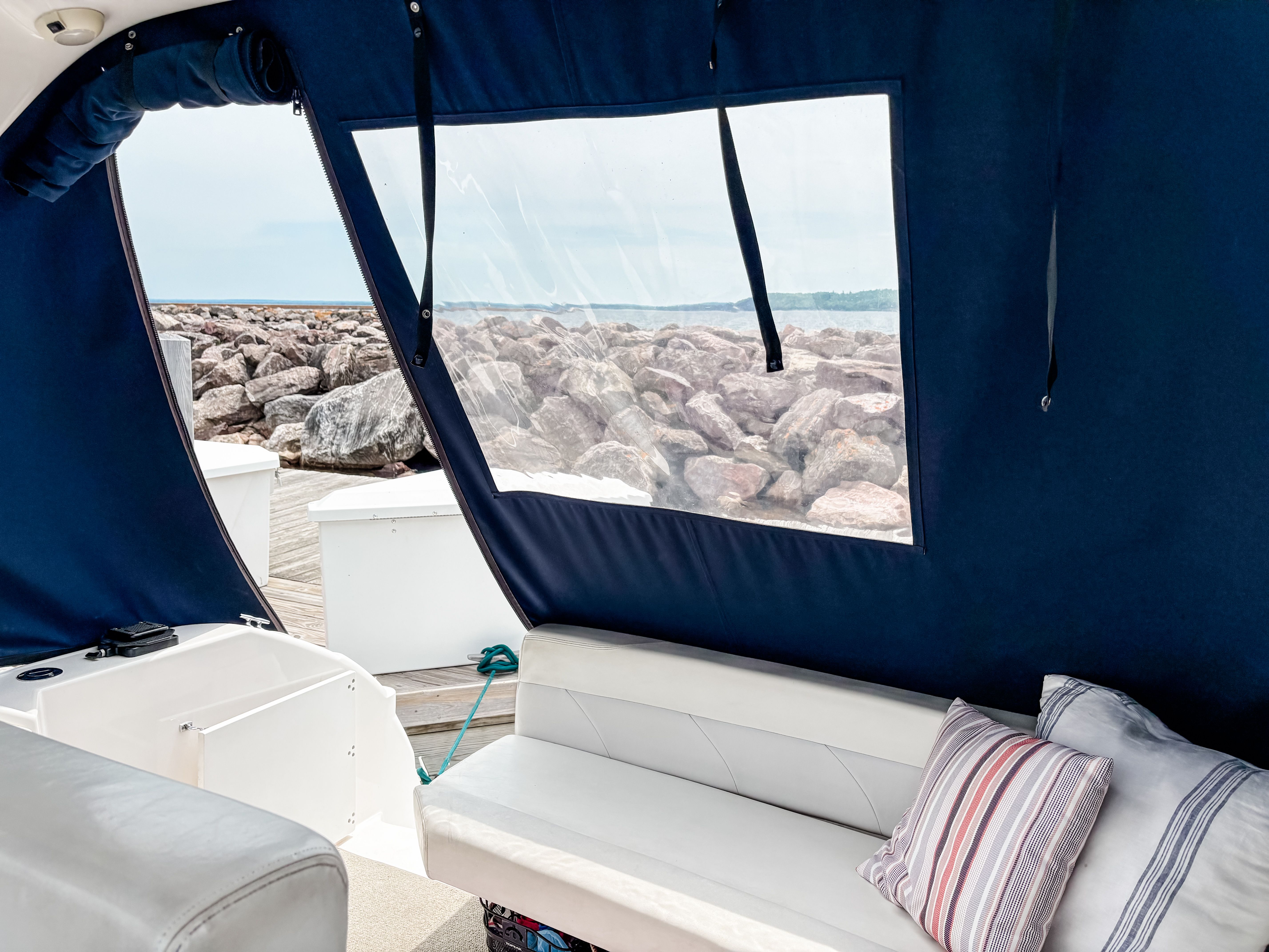 Interior of a 1997 Wellcraft Martinique with view of rocks.
