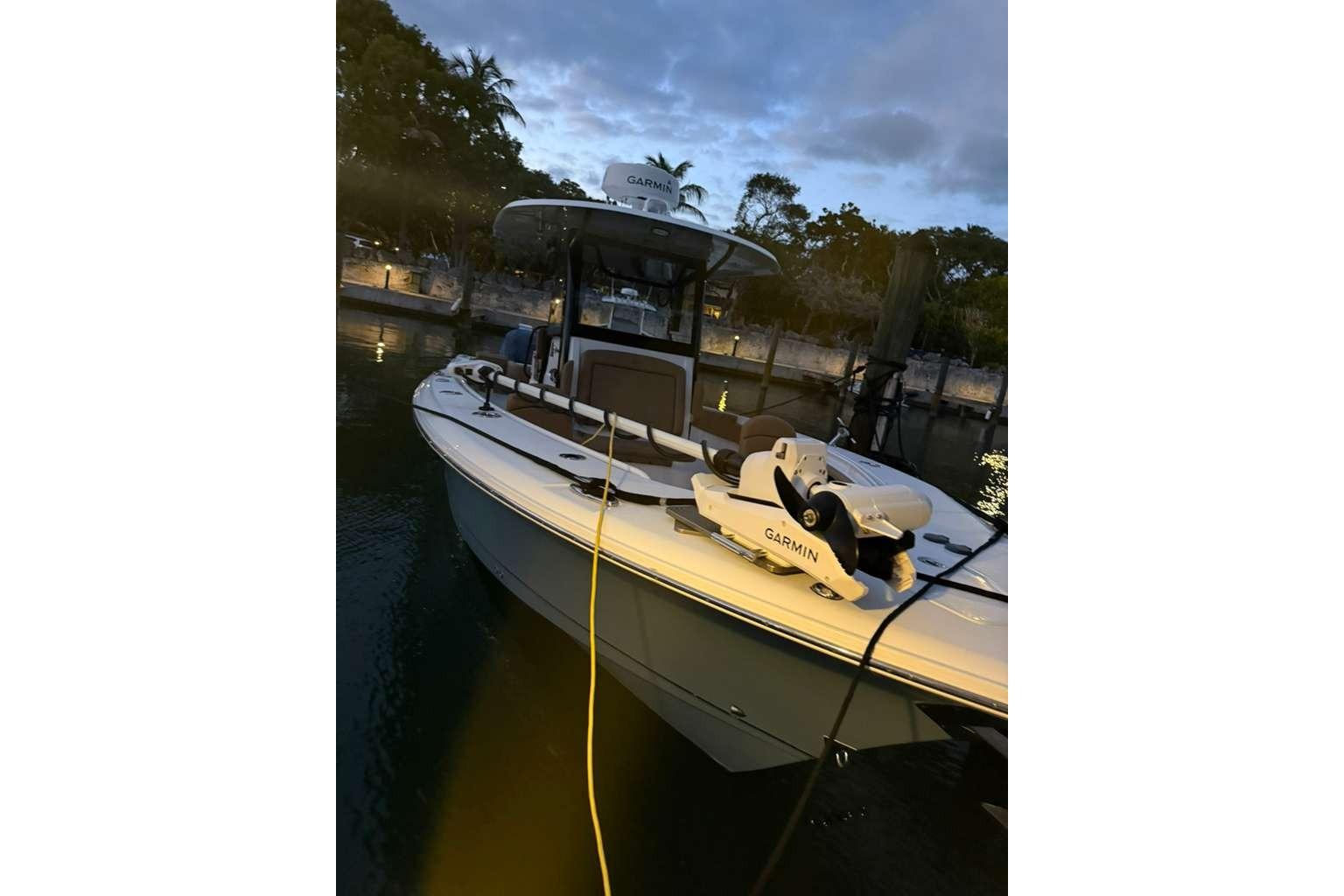 2021 Sea Hunt Gamefish 30 boat docked at twilight with Garmin equipment.