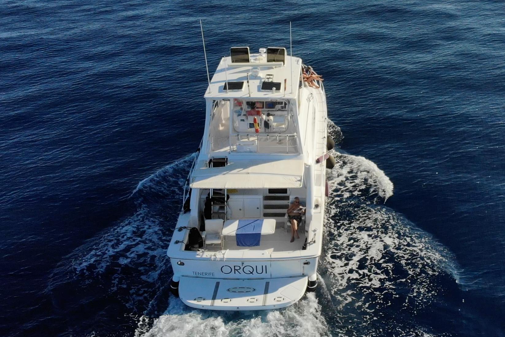 2004 Bertram 510 yacht cruising on open blue sea, aerial view.