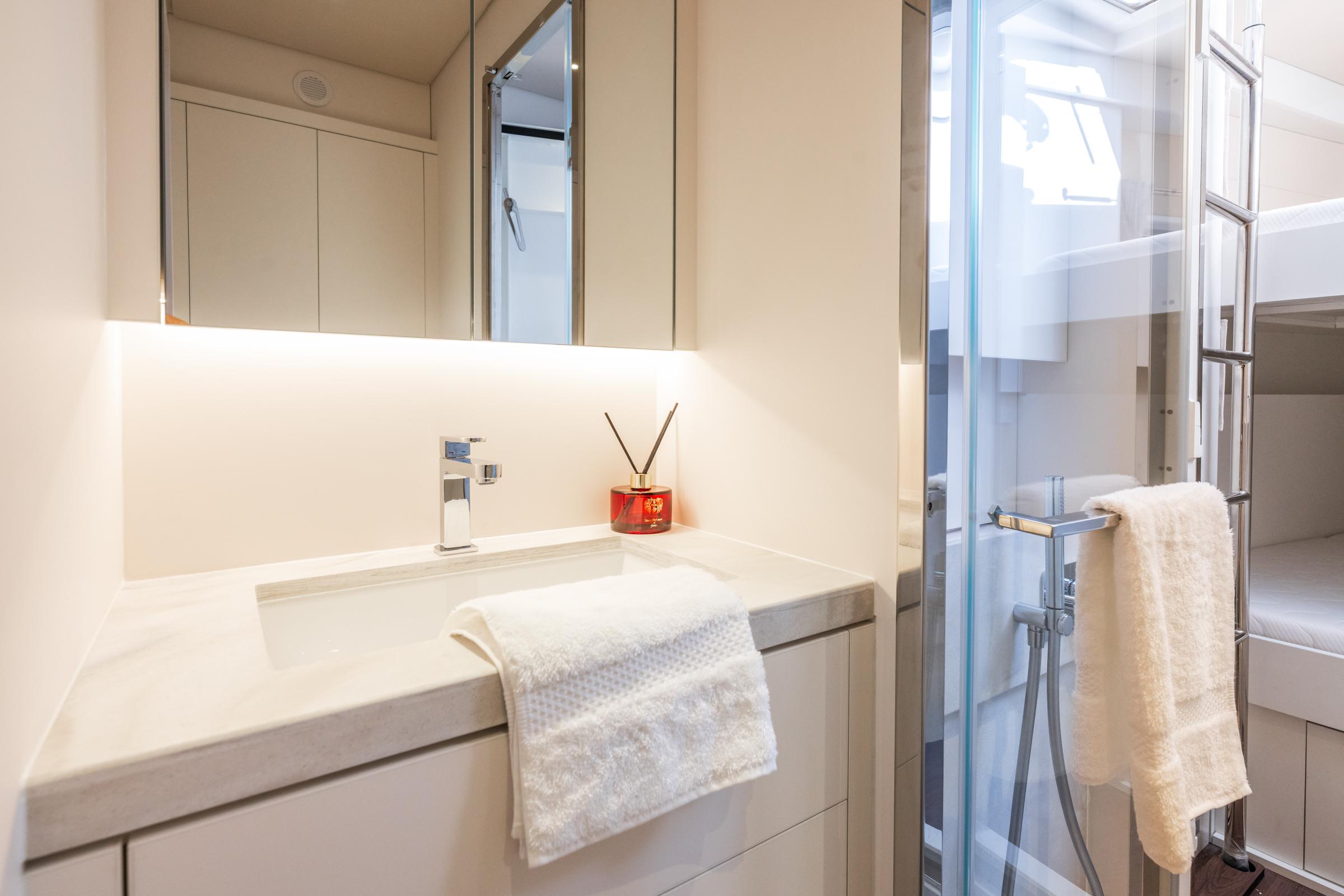Luxurious bathroom in 2025 Lagoon Eighty 2 yacht with modern fixtures and elegant design.