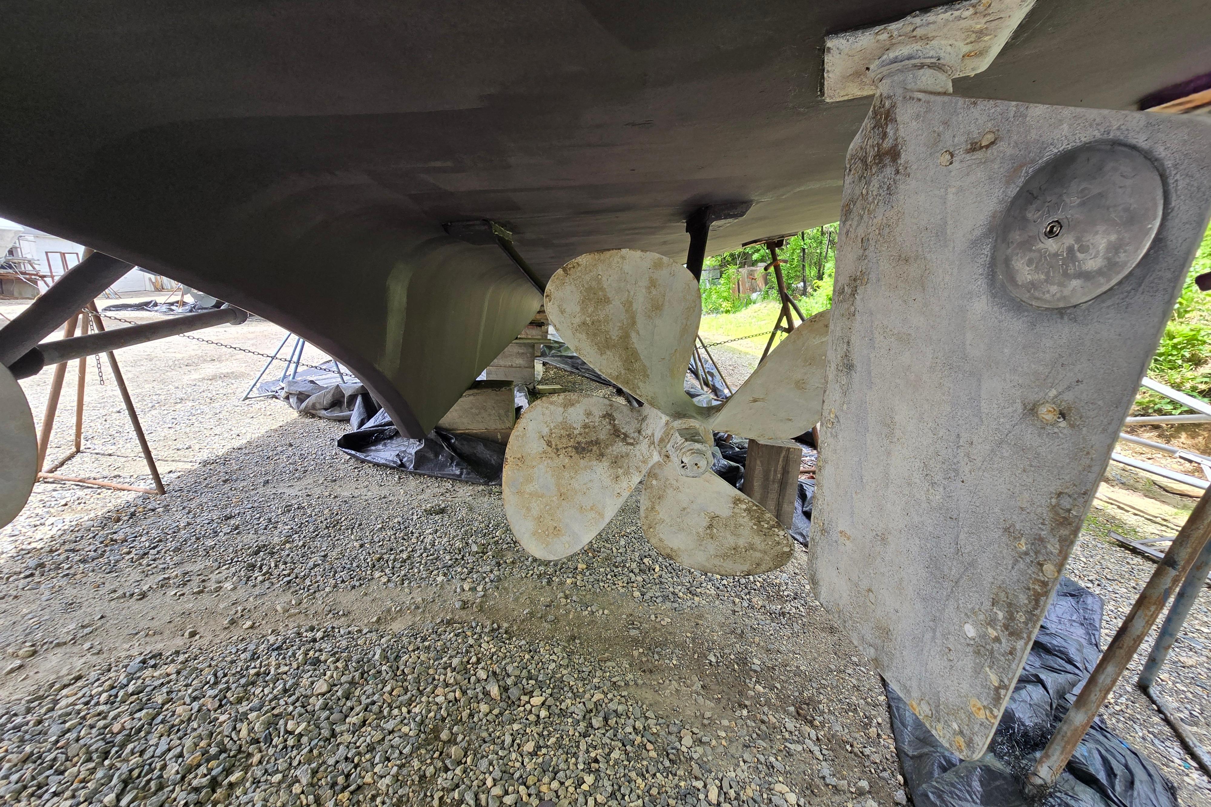 Underwater view of 1980 Hatteras 70 Motor Yacht propeller and rudder on dry dock.