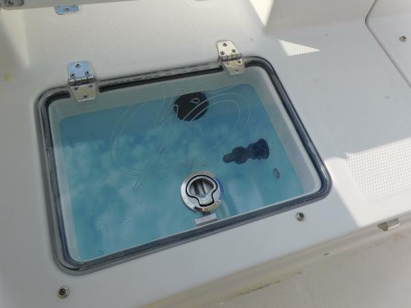 Livewell on 2025 Sailfish 232 CC boat, featuring a secure latch and clear lid.