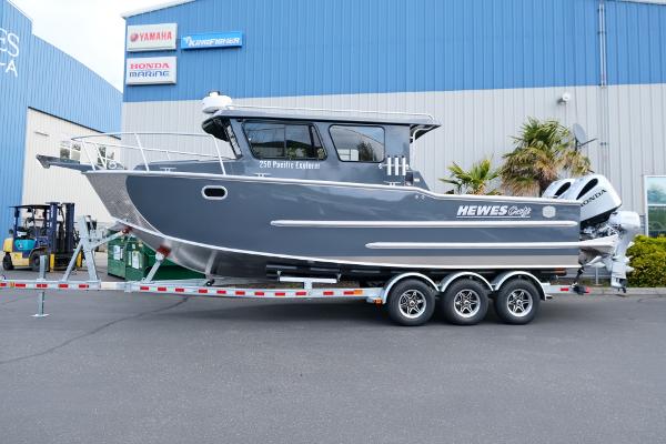 2024 Hewescraft 250 Explorer boat on trailer outside dealership.