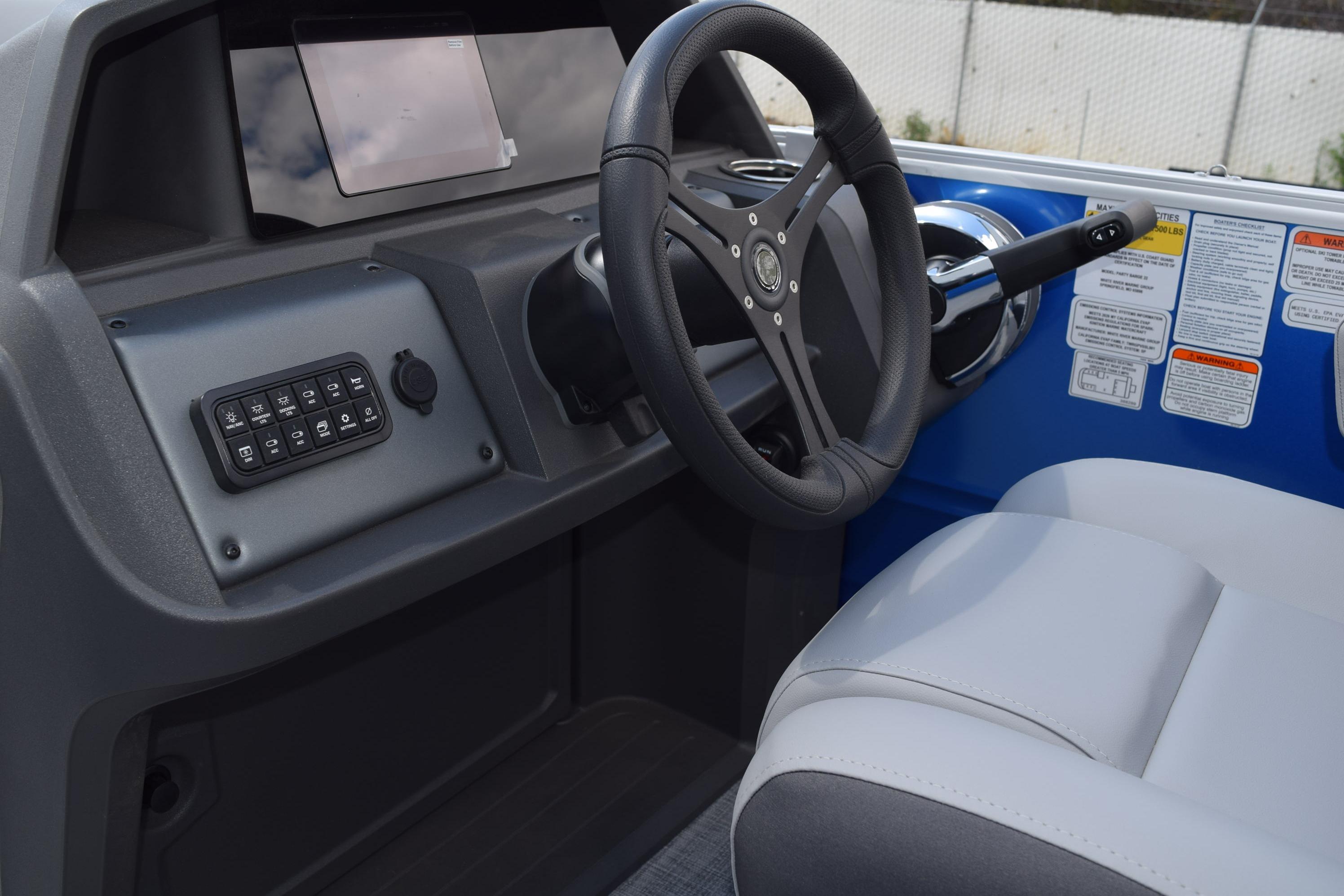 Interior view of 2026 Sun Tracker Party Barge 22 RF DLX boat dashboard and steering.