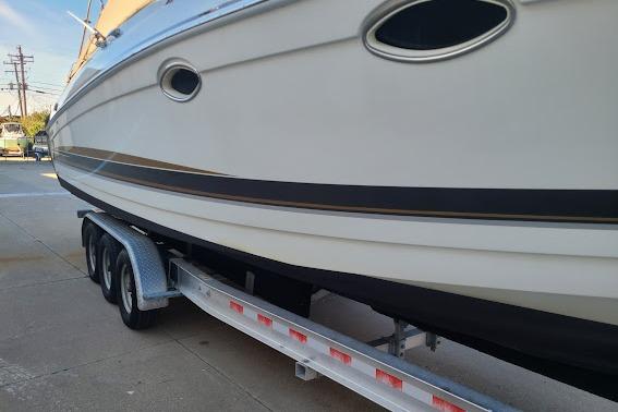 2002 Formula 330 Sun Sport boat on a trailer, side view.