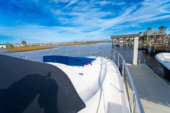2006 Sea Ray 580 Sedan Bridge yacht docked by a scenic waterfront.
