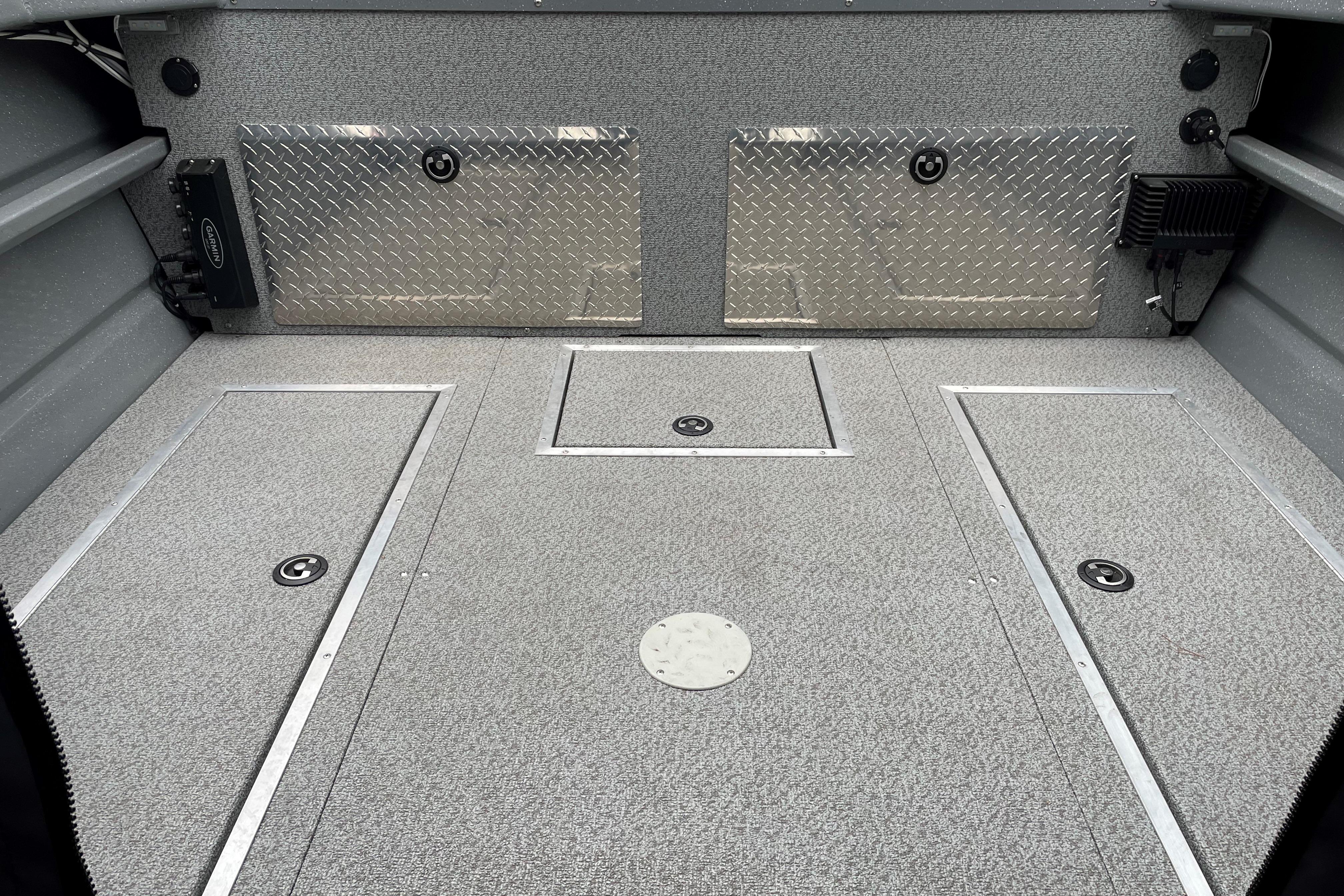 2024 Spartan 200 Astoria boat interior with diamond plate accents and storage compartments.