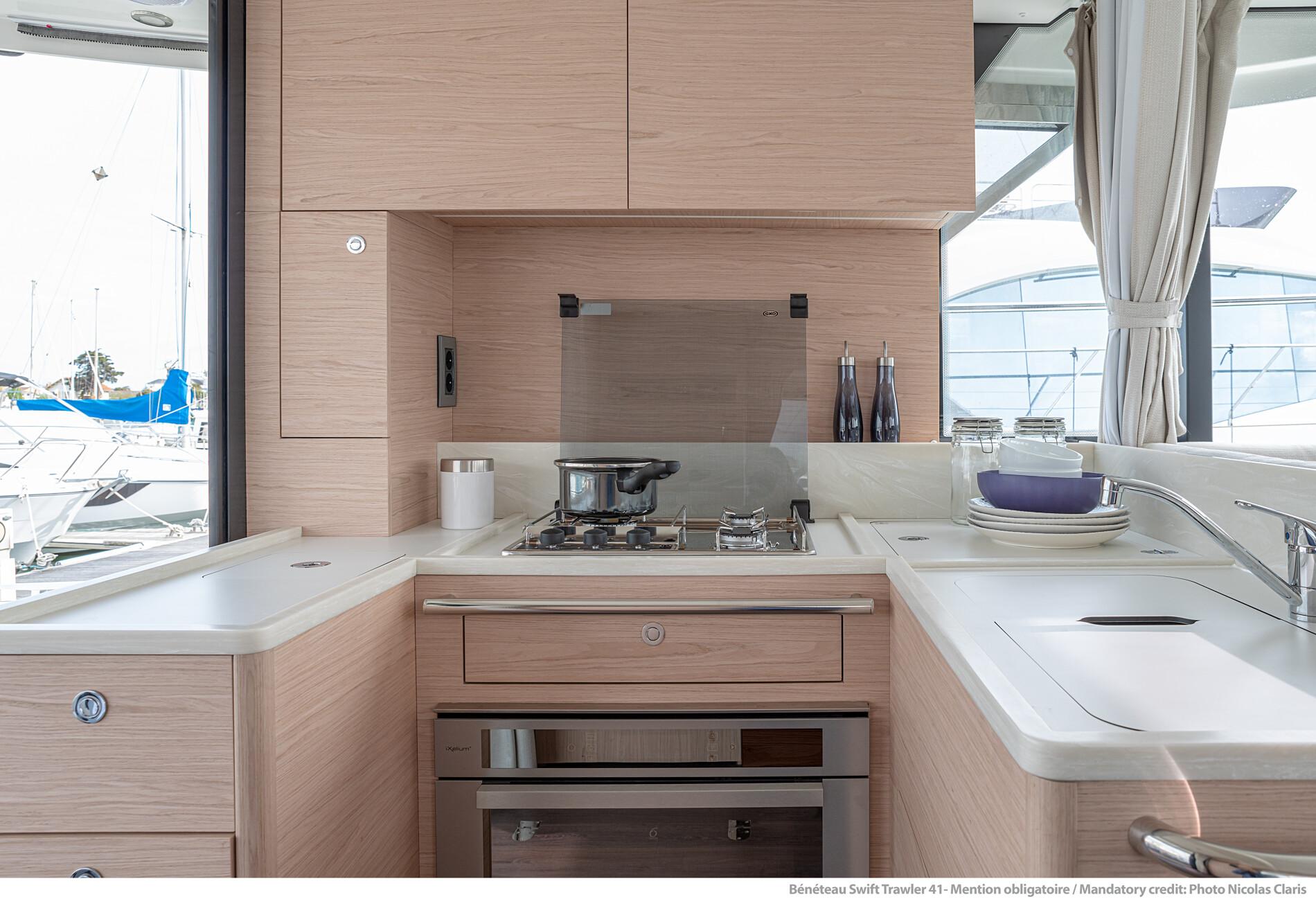 Modern kitchen interior of 2025 Beneteau Swift Trawler 41 Fly yacht.