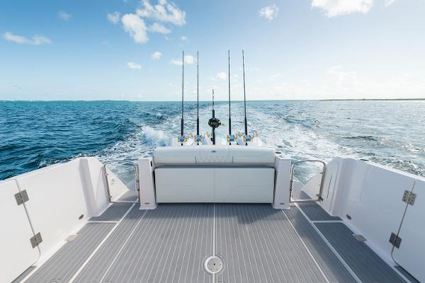 Manufacturer Provided Image: 2026 Regal 38 SAV boat deck with fishing rods, cruising on open sea.