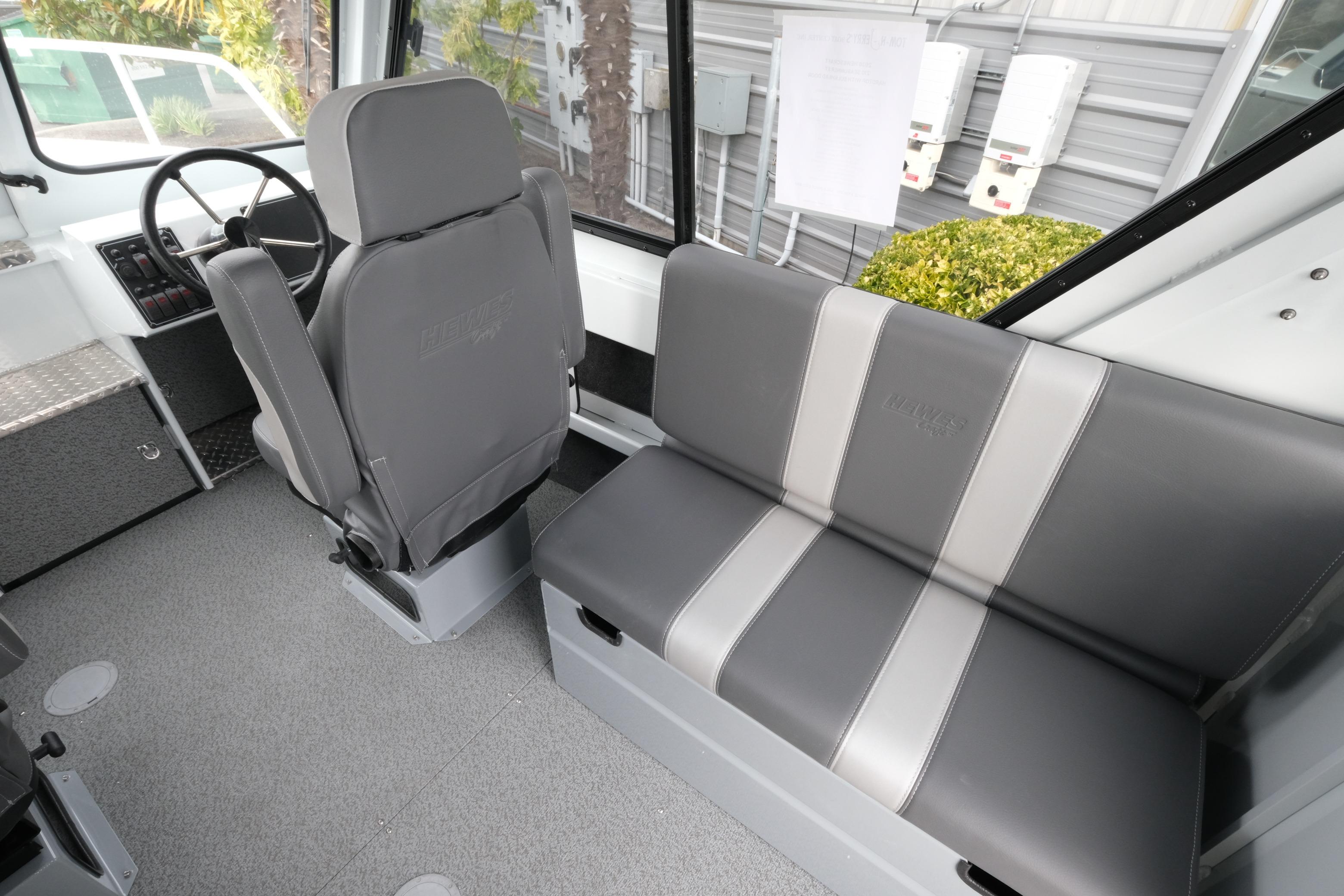 Interior of 2026 Hewescraft 210 Sea Runner ET Hardtop with gray seating and steering wheel.