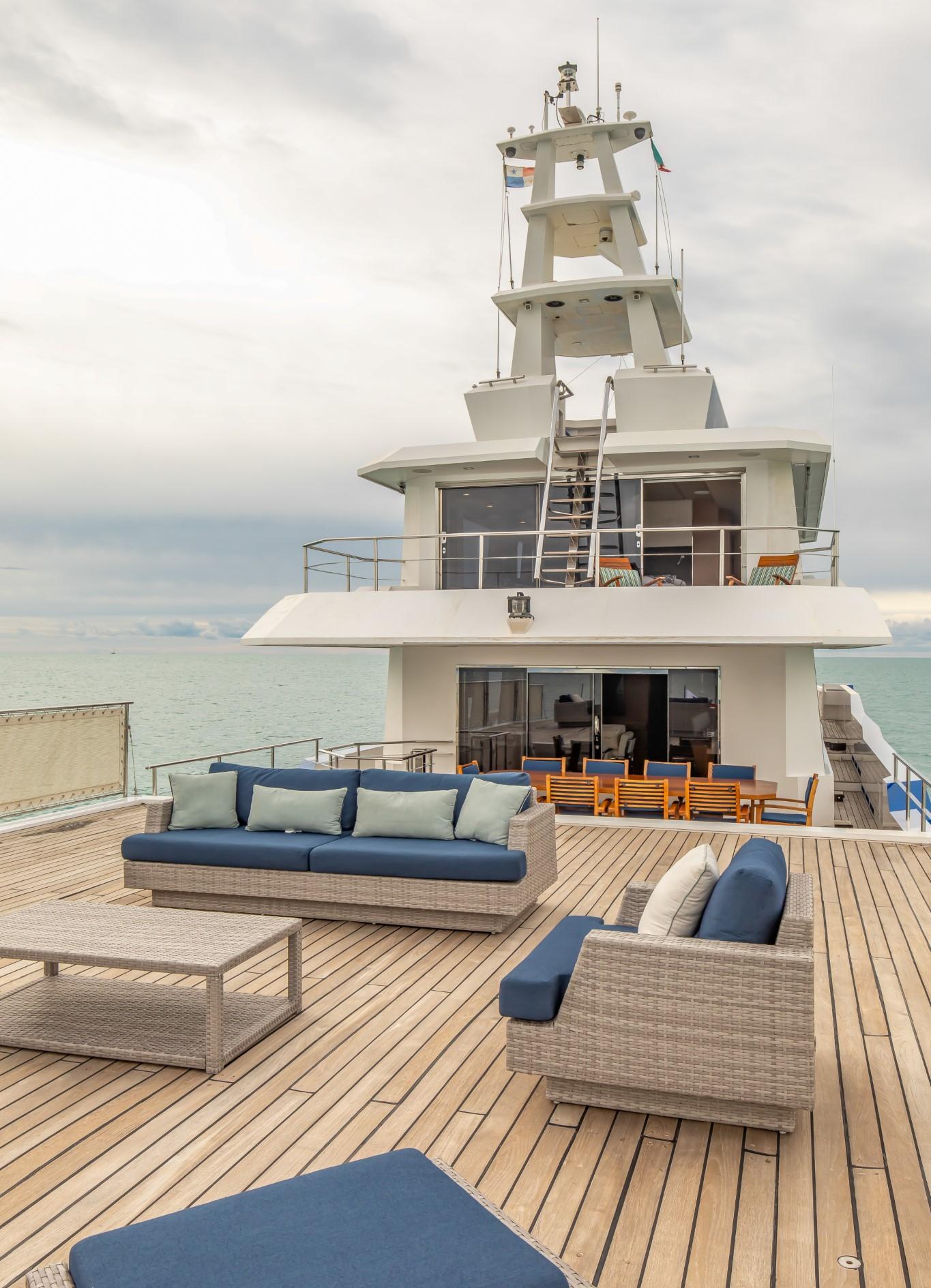Luxurious 1992 Custom Niigata yacht deck with modern seating and ocean view.