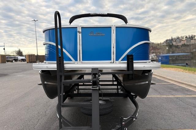 2026 Sun Tracker Party Barge 16 DLX pontoon boat on trailer, parked outdoors.
