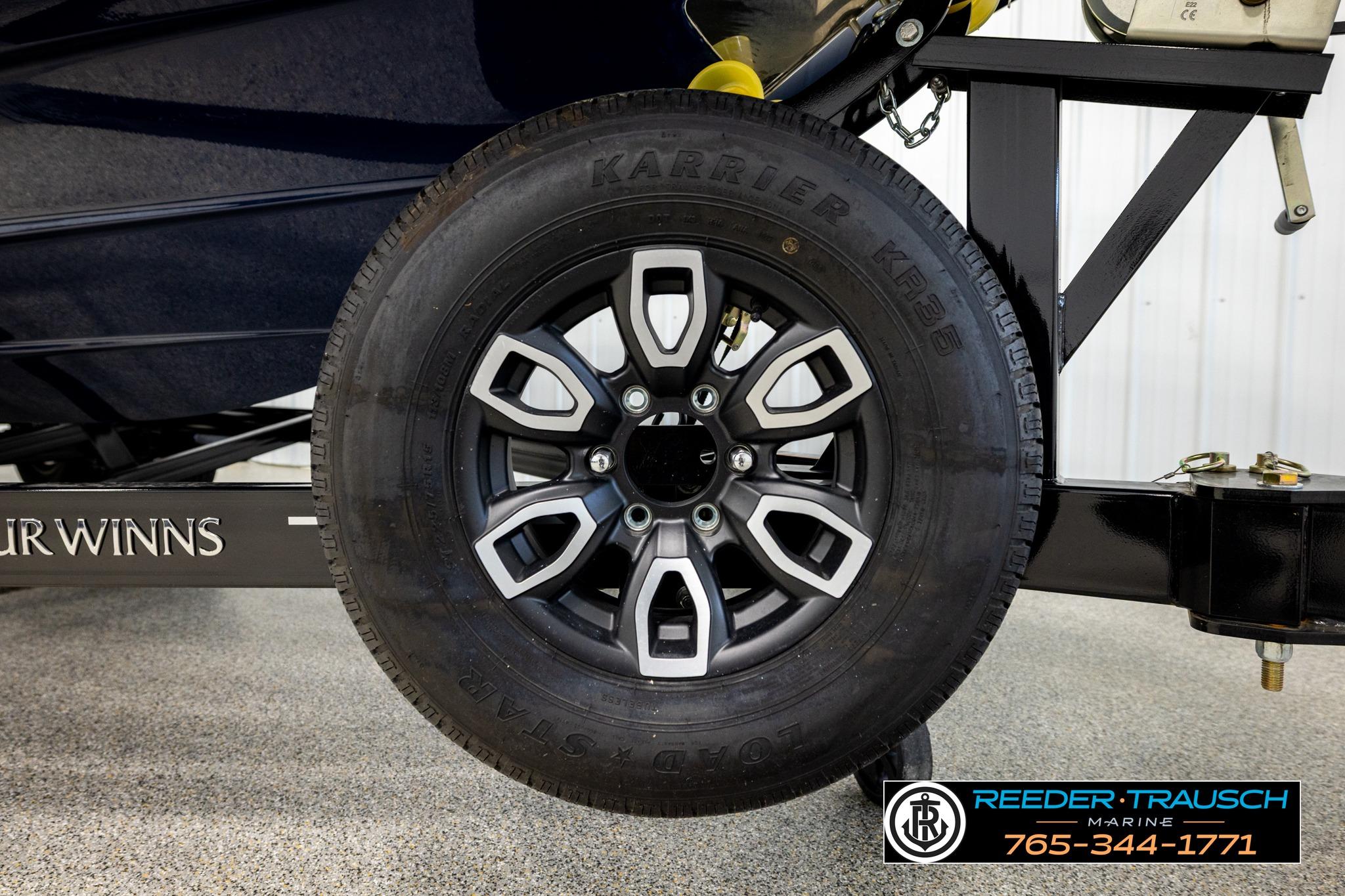2024 FOURWINNS HD5 Surf trailer tire with alloy wheel, Reeder-Trausch Marine branding.