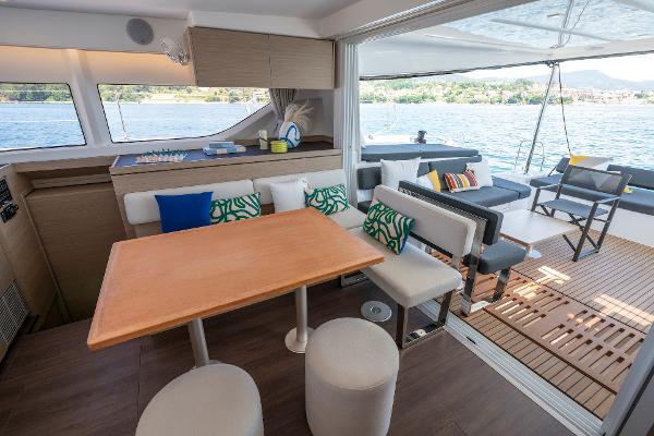 Luxurious interior of 2025 Lagoon 43 yacht with modern seating and scenic water view.