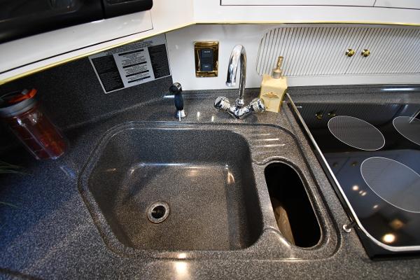 1997 Sea Ray 400 Sundancer kitchen sink and stove area with modern fixtures.