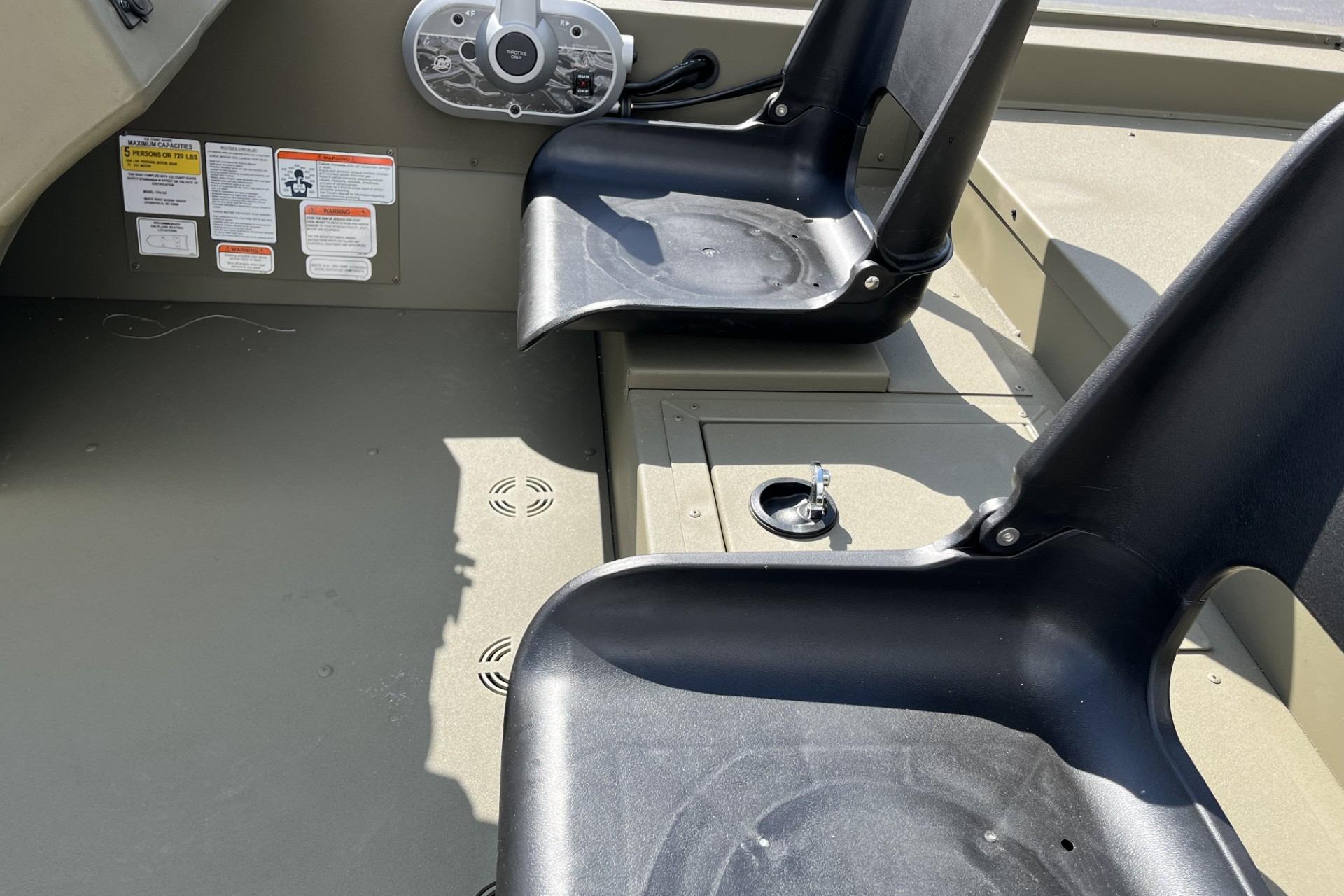 Interior of 2026 Tracker Grizzly 1754 SC boat with seating and control panel.