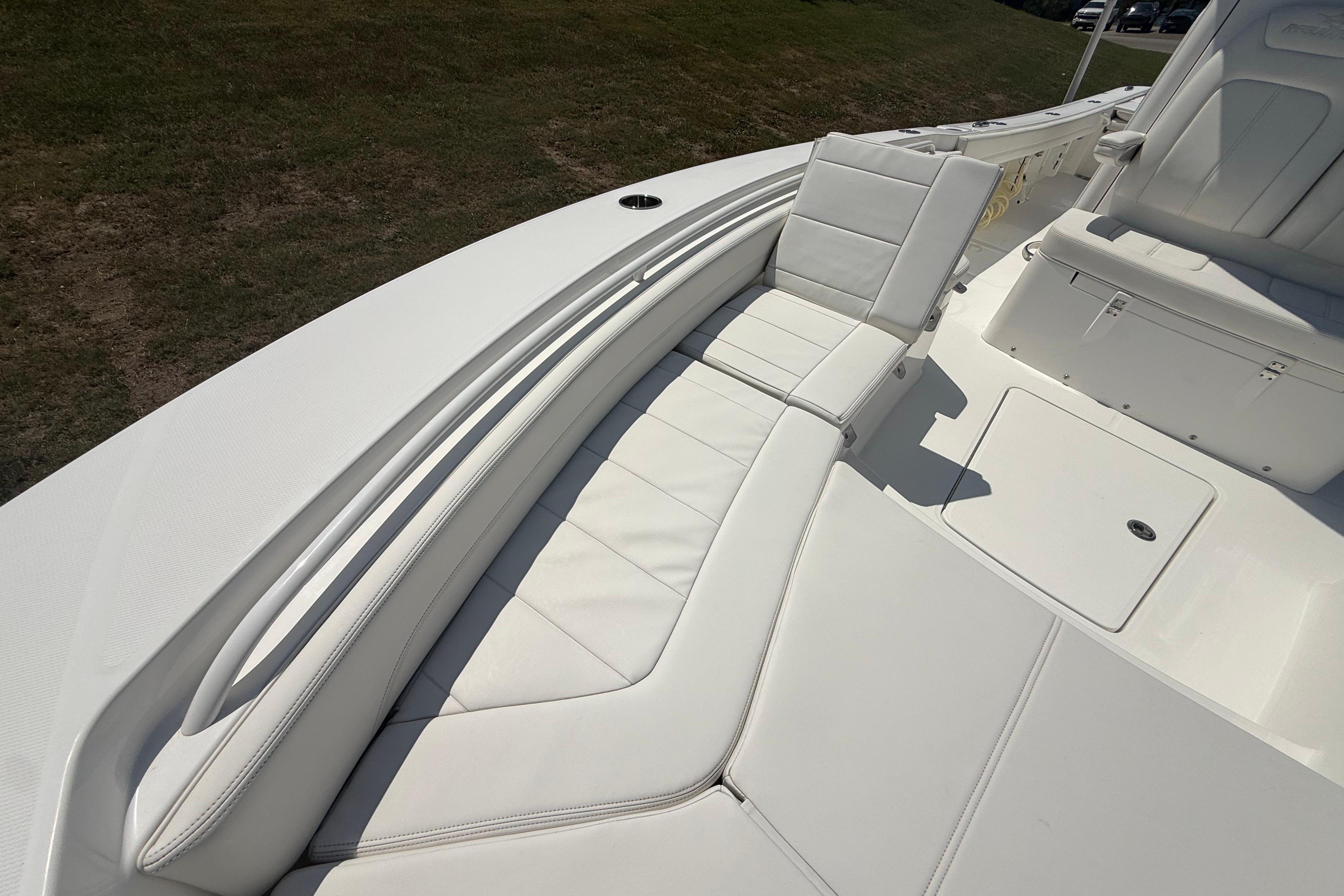 2023 Regulator 26XO boat interior with white cushioned seating and storage compartments.