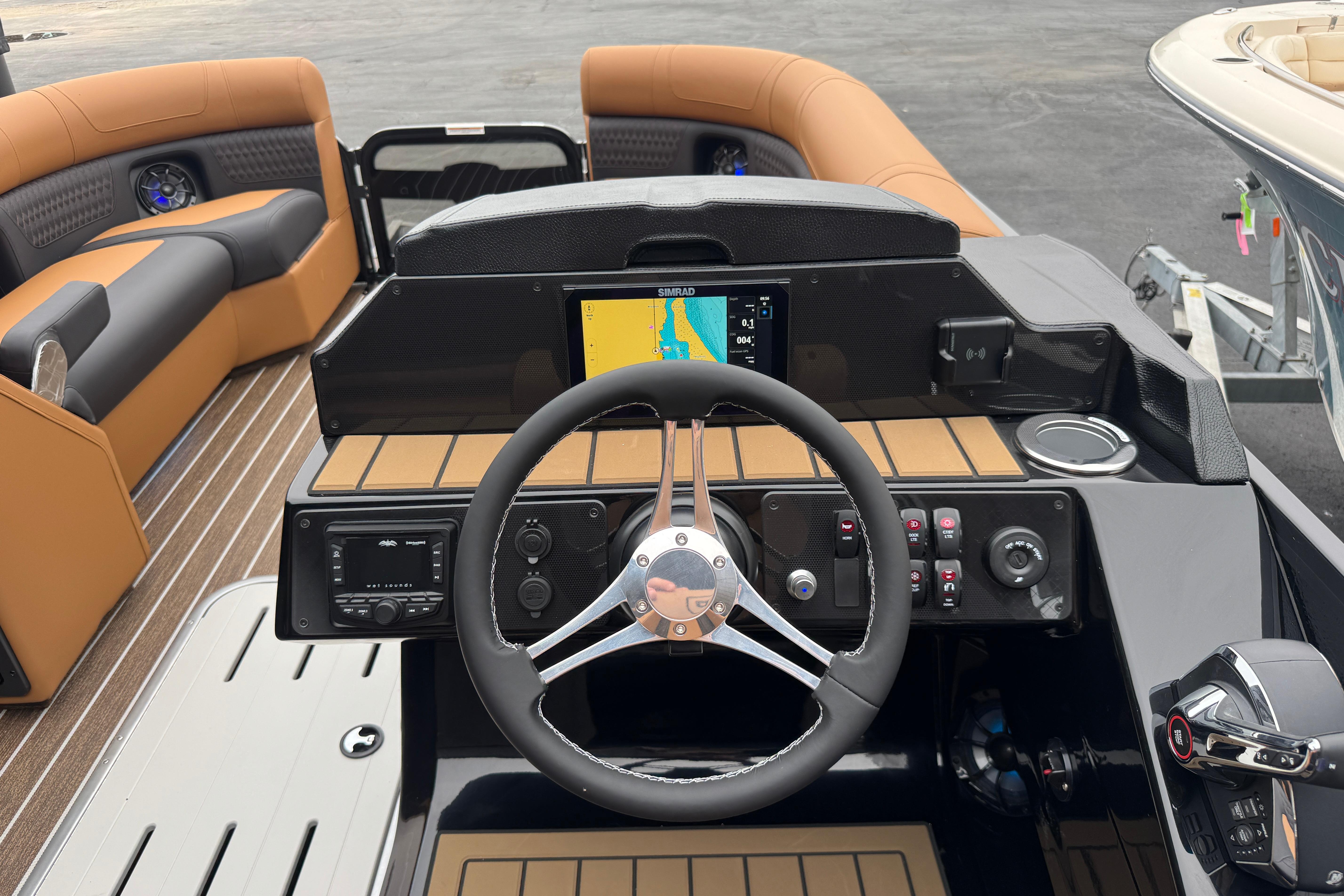 2026 Premier 230 Solaris RL boat dashboard with steering wheel and navigation display.