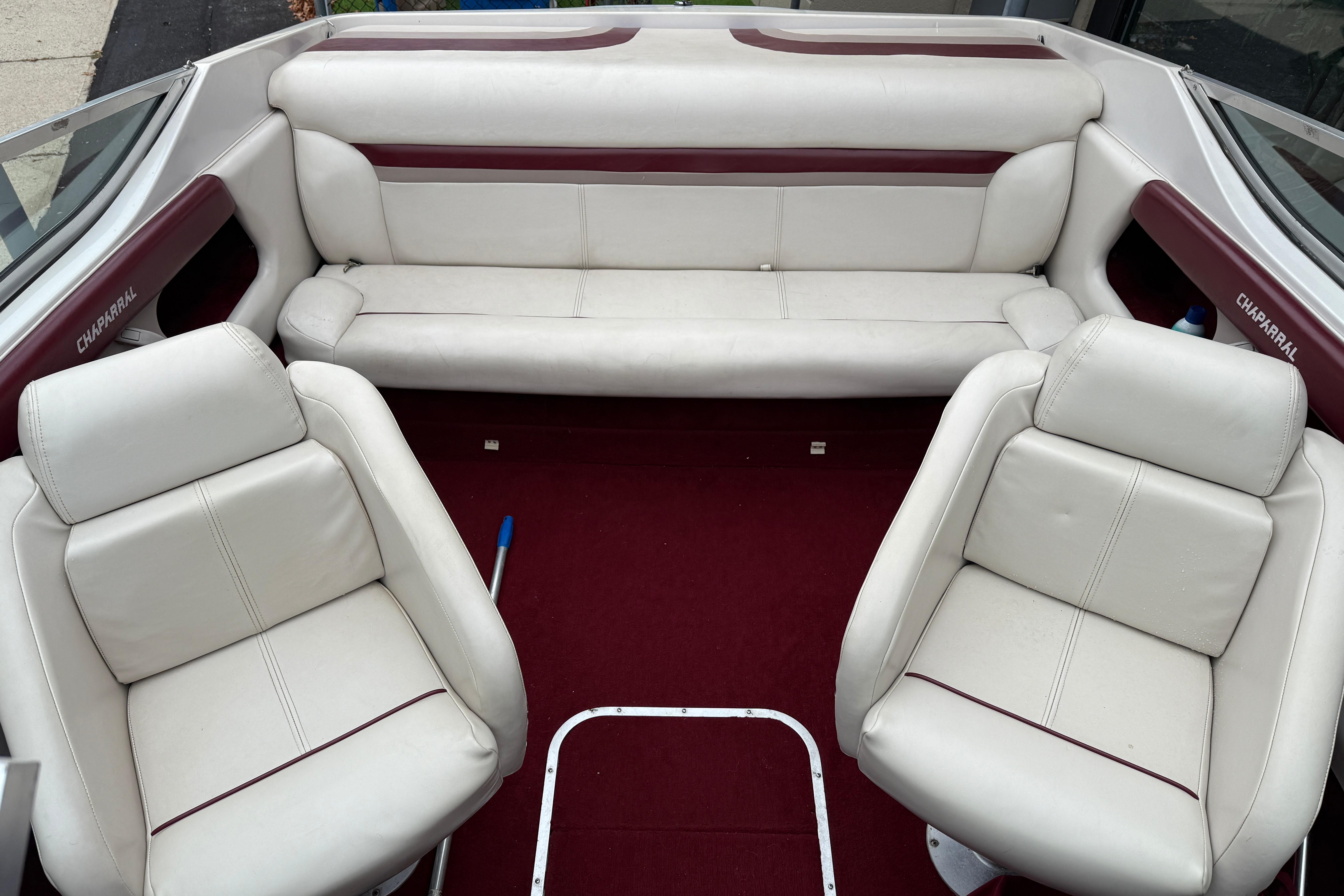 Interior of a 1999 Chaparral 1930 SS boat with white and maroon seating.
