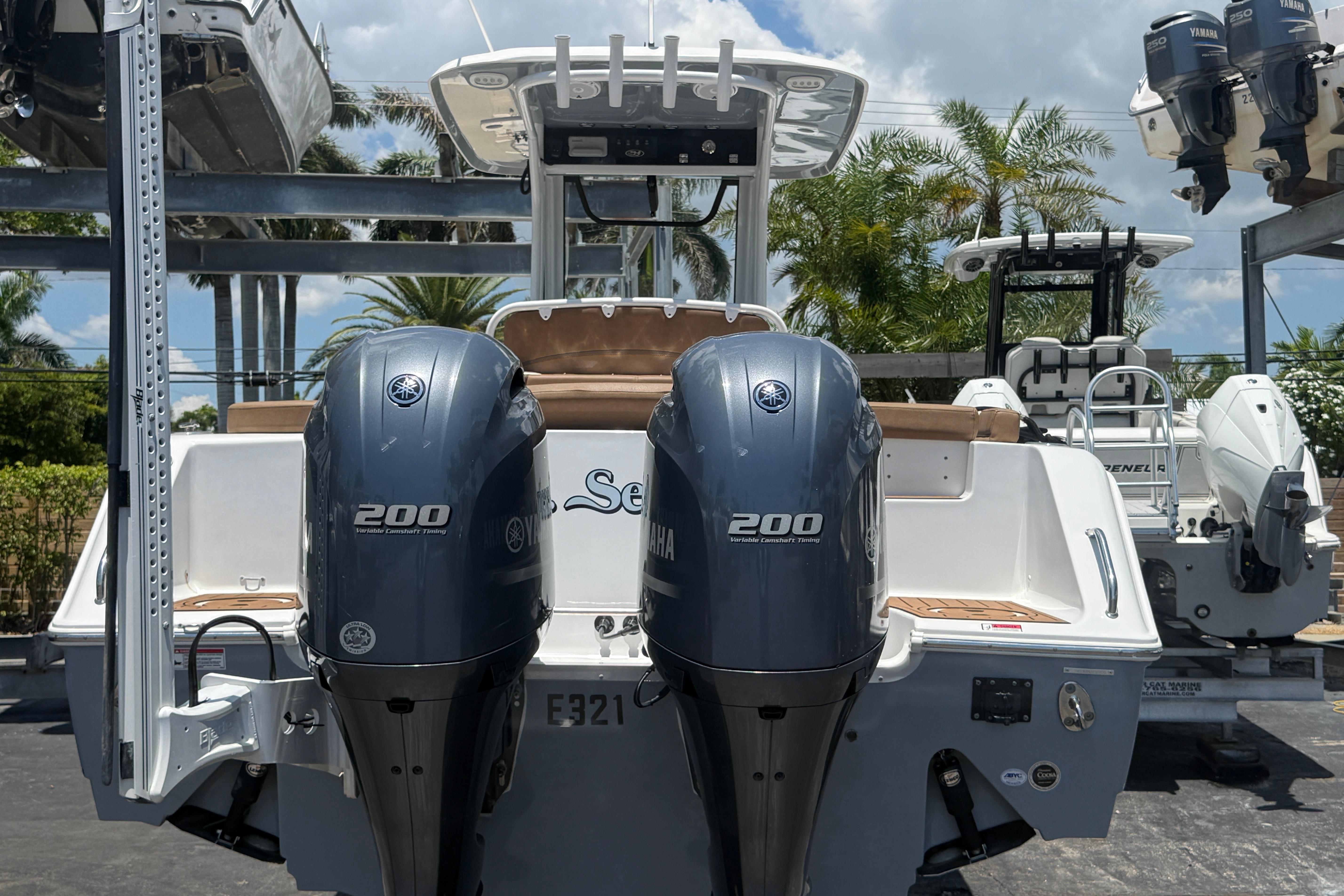 2020 Sea Hunt Ultra 275 SE boat with dual Yamaha 200 engines, docked outdoors.