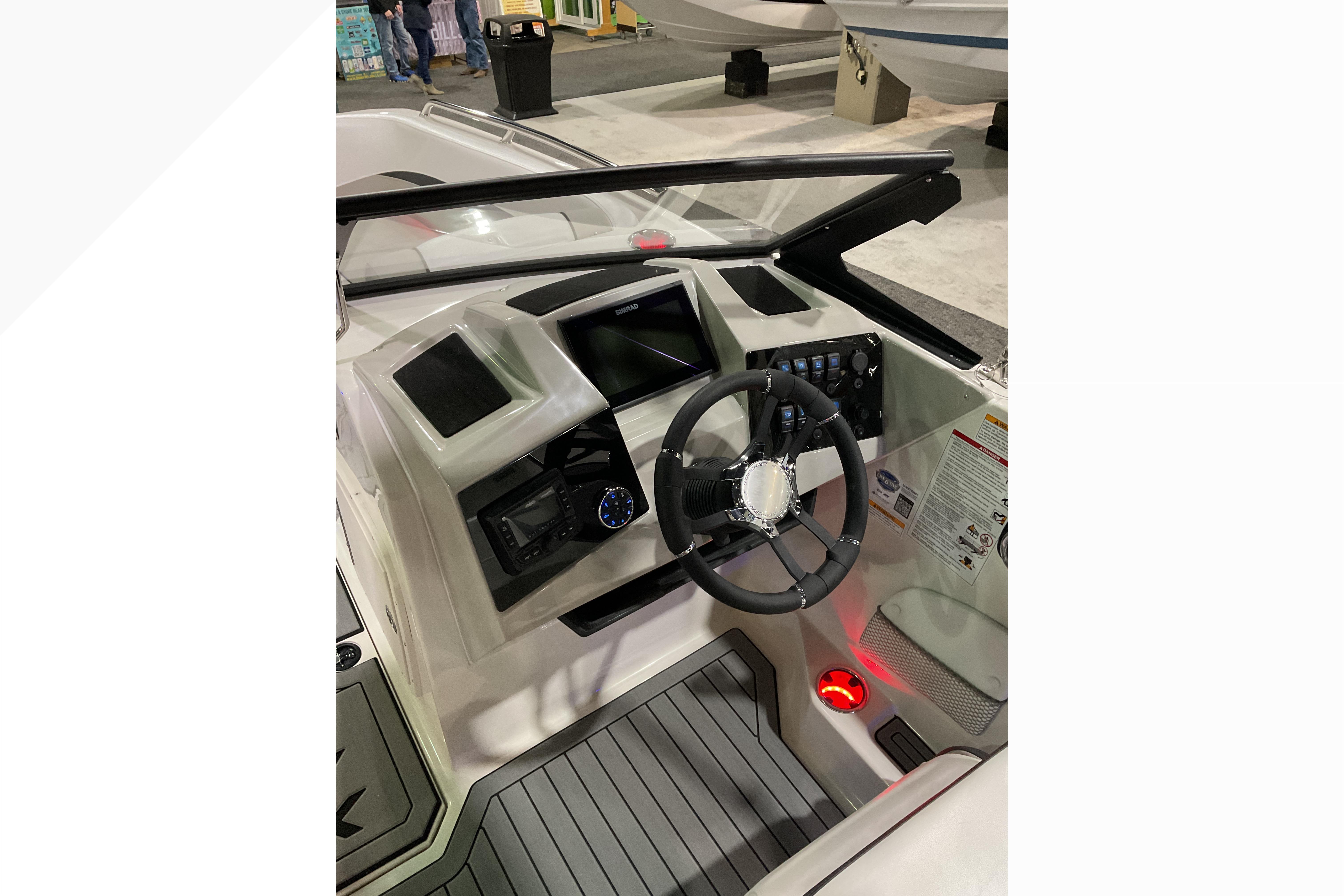2026 Starcraft SVX 210 DC OB boat dashboard with steering wheel and control panel.