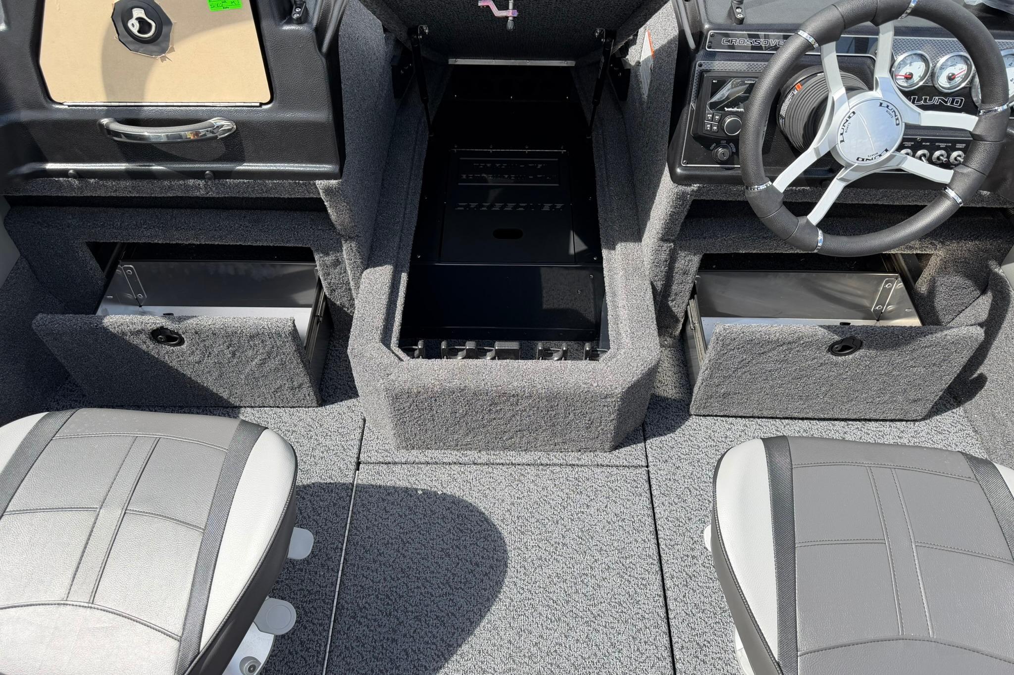 Interior of 2027 Lund 1875 Crossover XS boat with steering wheel and storage compartments.