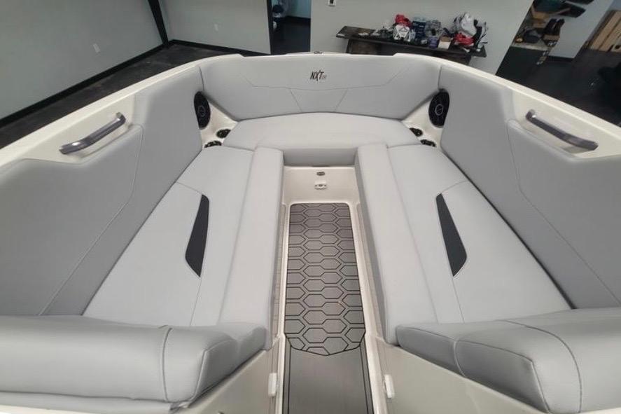 2022 MasterCraft NXT24 boat interior with gray seating and hexagonal floor design.