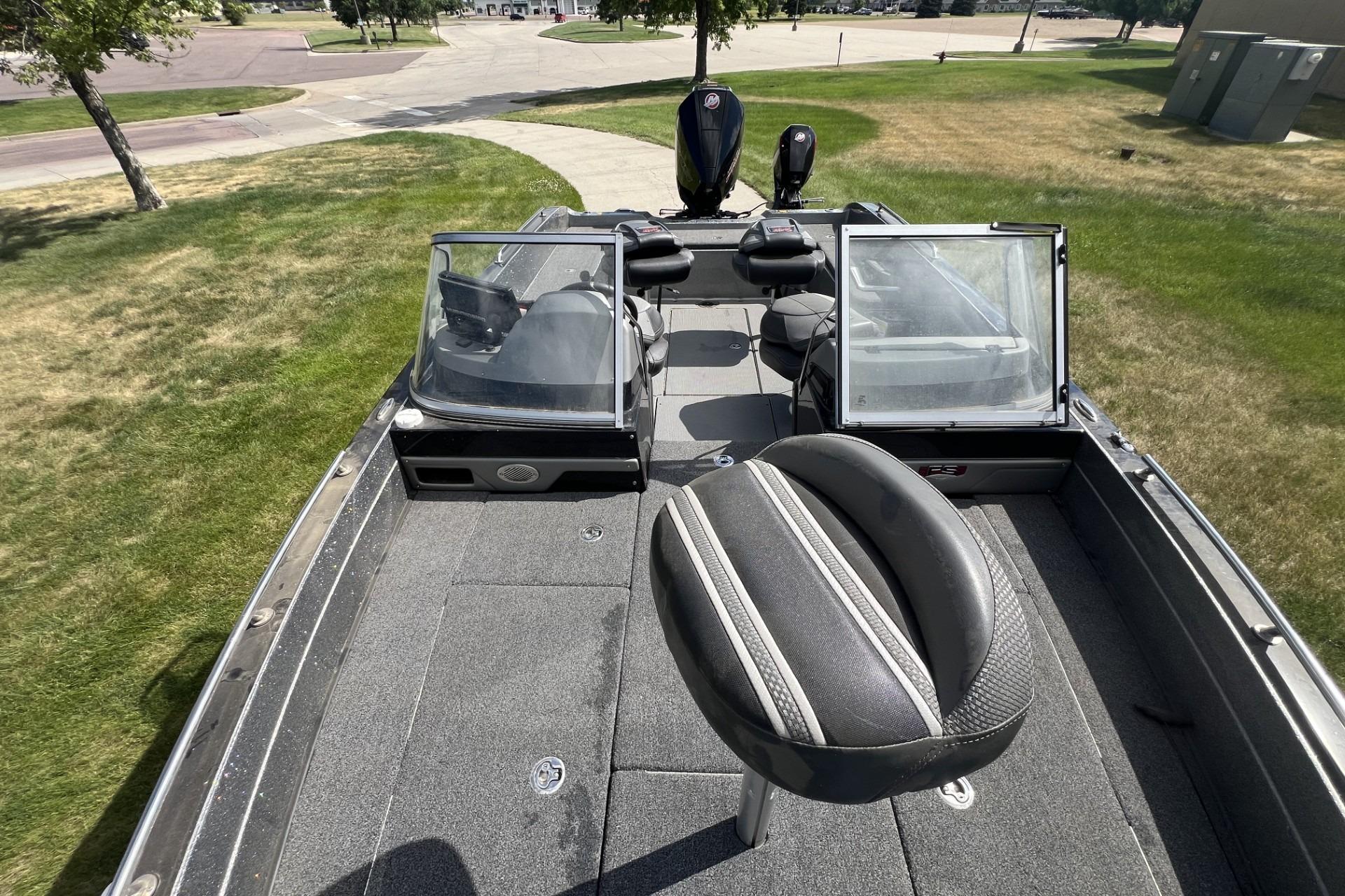 2023 Ranger 620FS Cup-Equipped boat with seating, parked on grass.
