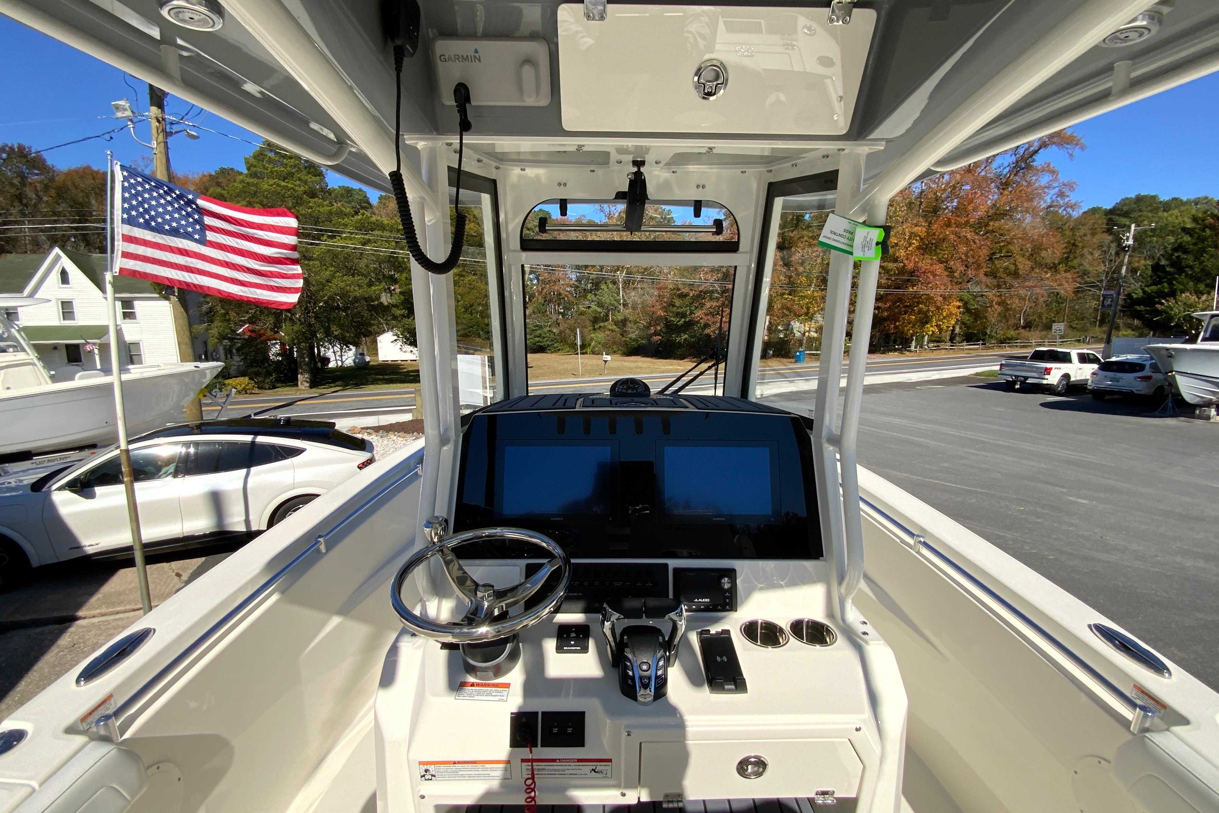 2026 Cobia 265 Center Console boat dashboard with steering wheel and American flag.