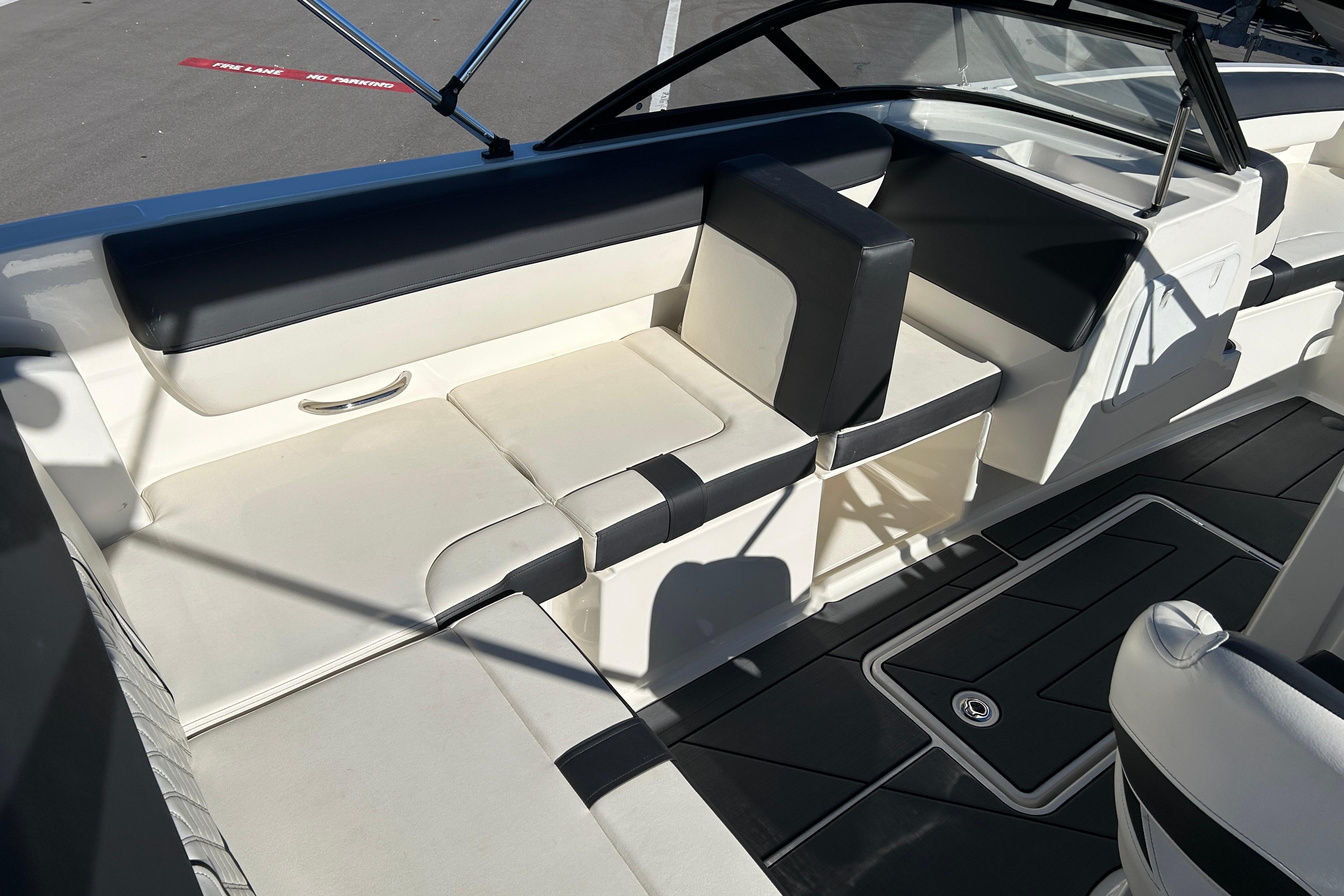 2020 Bayliner DX 2000 boat interior with white and black seating and flooring.
