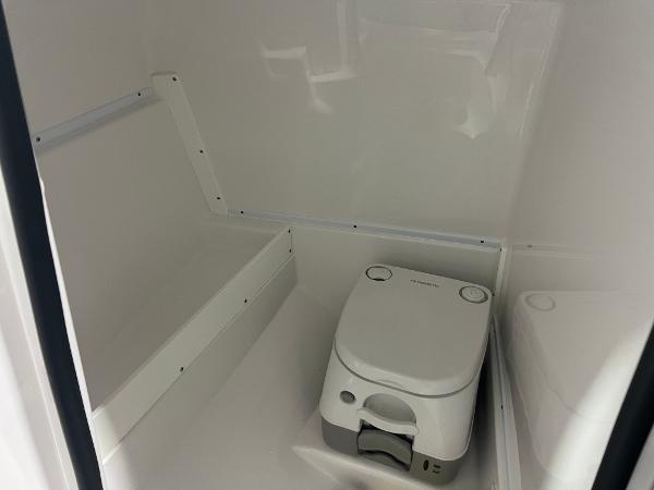 2024 Monterey M4 boat interior with compact portable toilet.