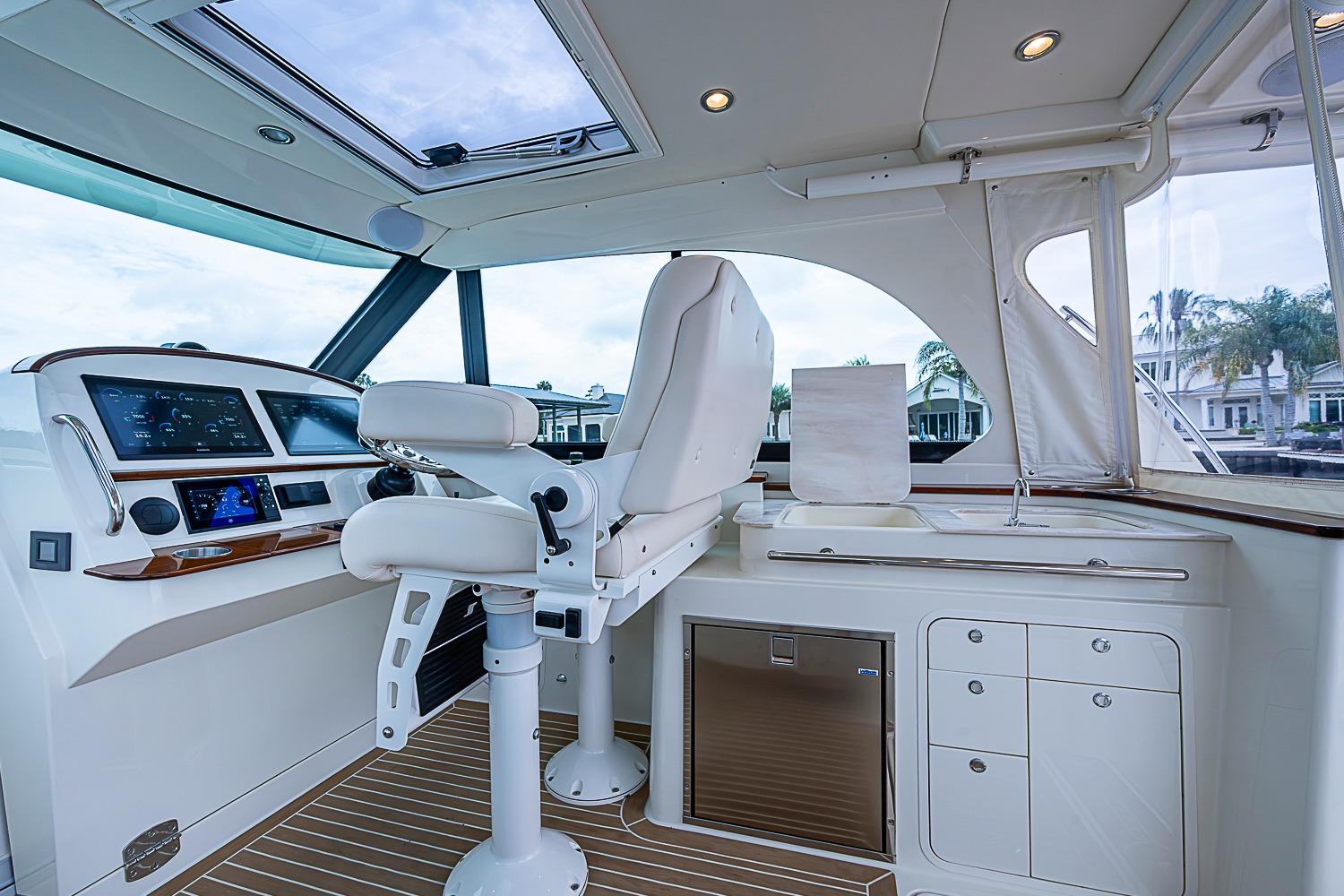 Interior of 2023 Hinckley Sport Boat 40 X, featuring helm and seating area.