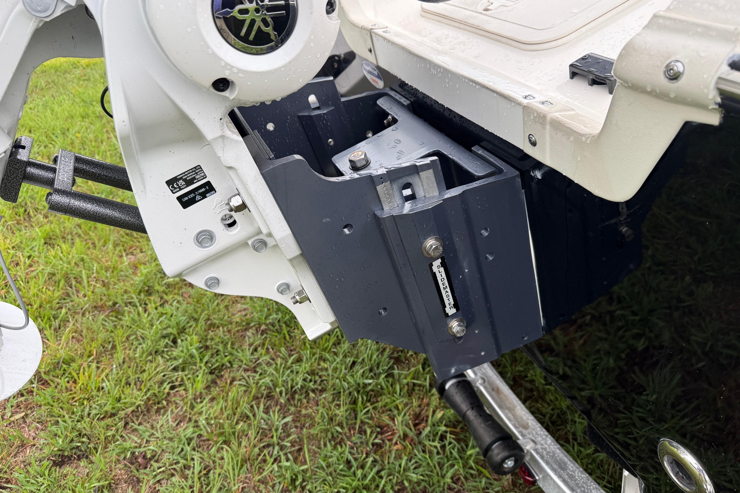 2026 Skeeter SX2350 boat motor mount detail with wet surface and grassy background.