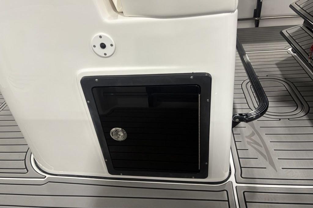 2026 Tidewater 3100 Carolina Bay boat interior with storage compartment and sleek flooring.