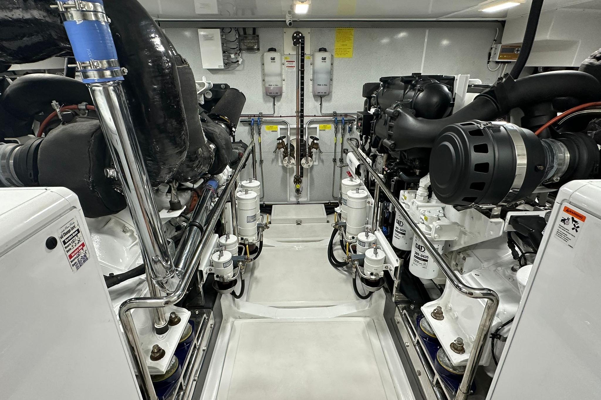 Engine room of 2023 Marlow Explorer 66E-CB yacht, showcasing advanced machinery and components.