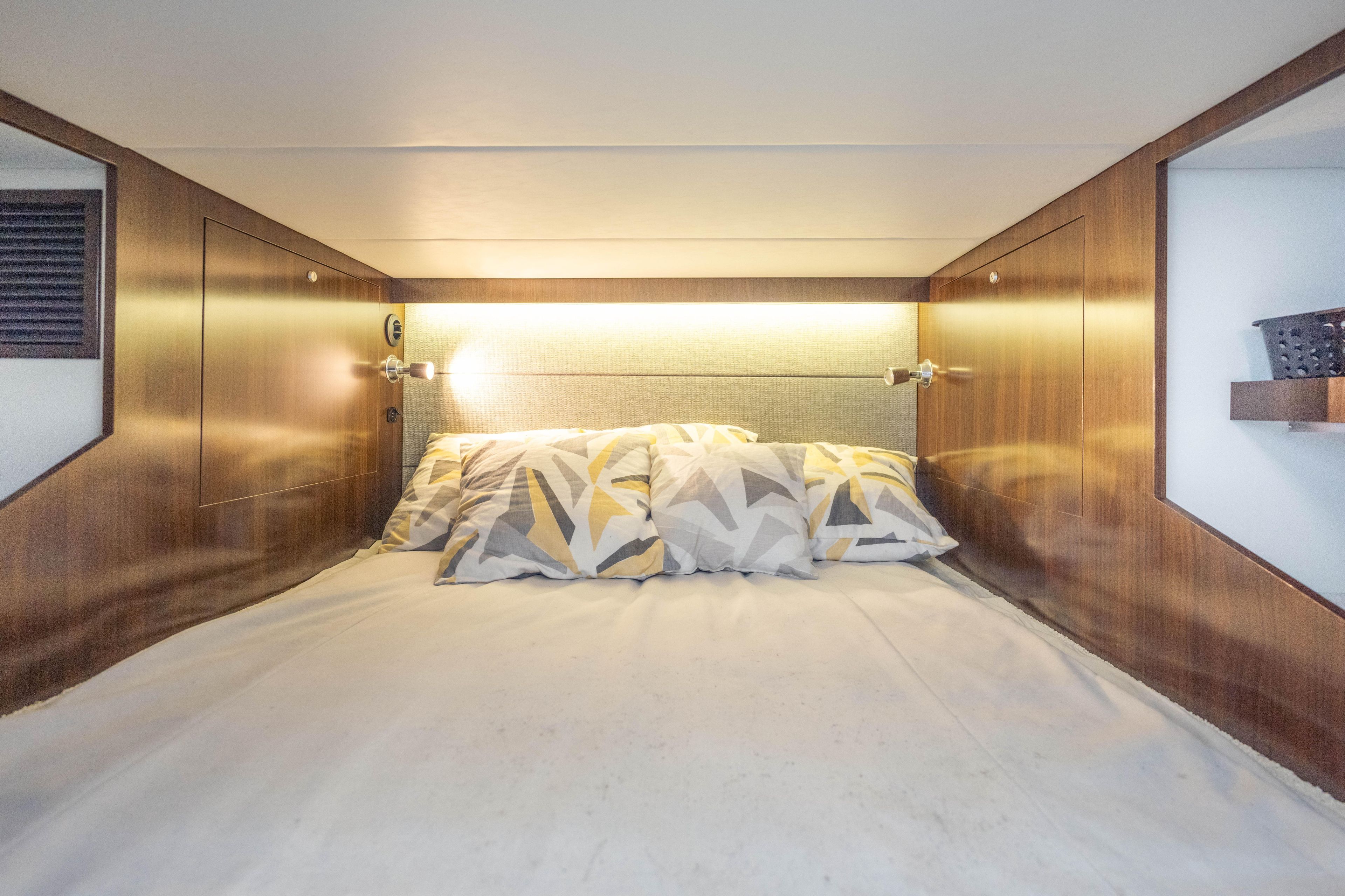Luxurious cabin interior of 2021 Cruisers Yachts 38 GLS with modern bedding.