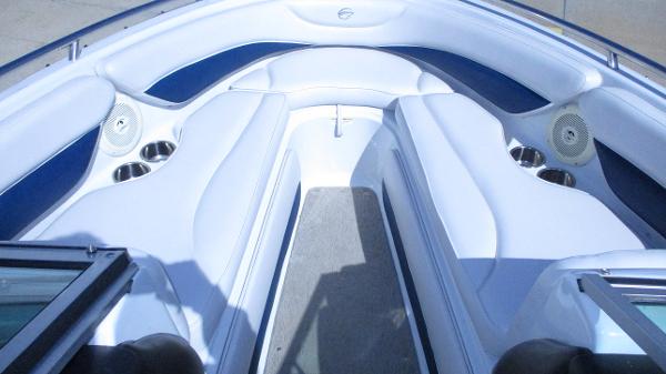 Interior view of 2012 Crownline 21 SS boat with white seating and speakers.