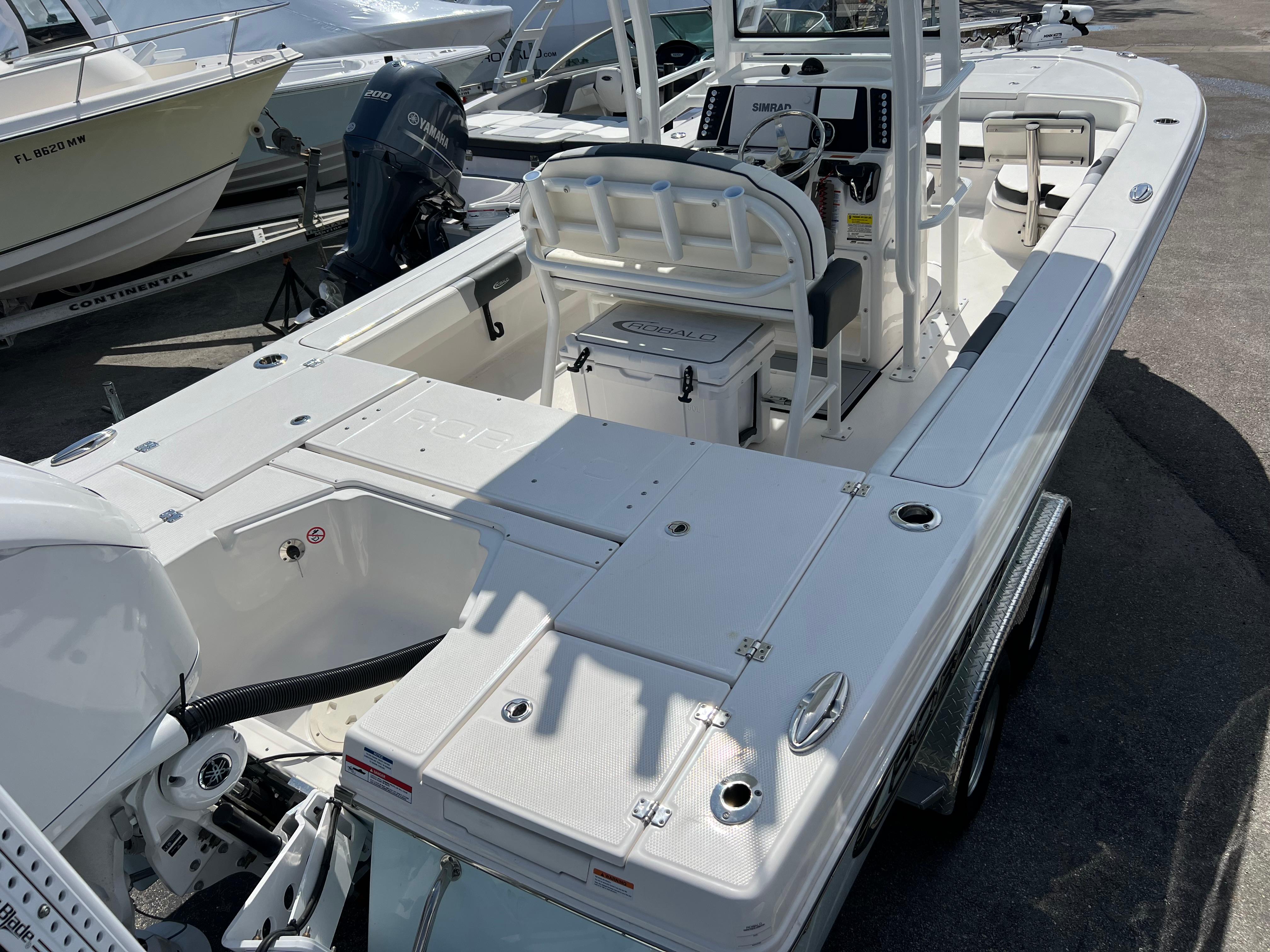 2024 Robalo 246 Sky Deck boat, white exterior, docked at marina.
