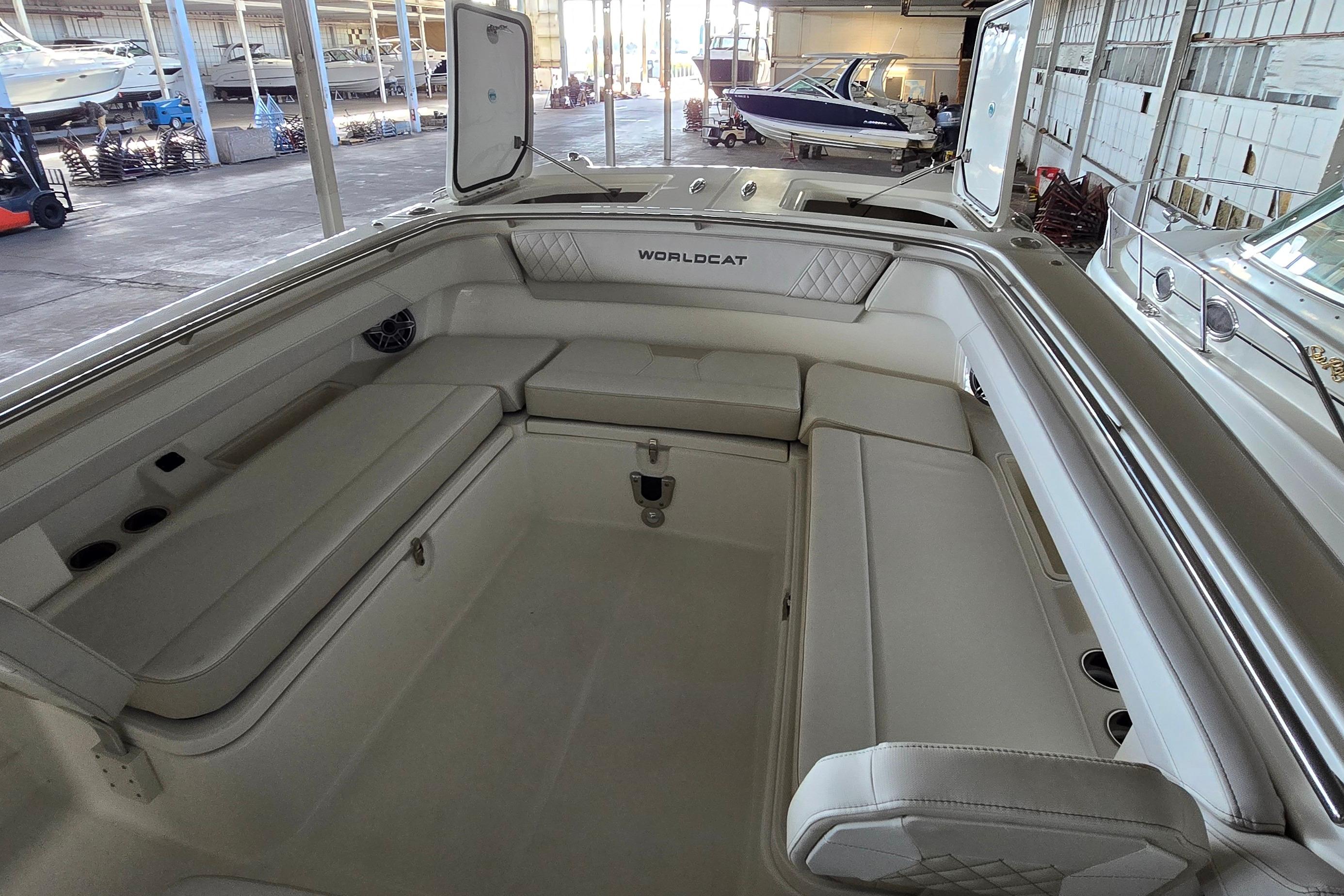 2024 WorldCat 280 CC-X boat interior with spacious seating in a marina setting.