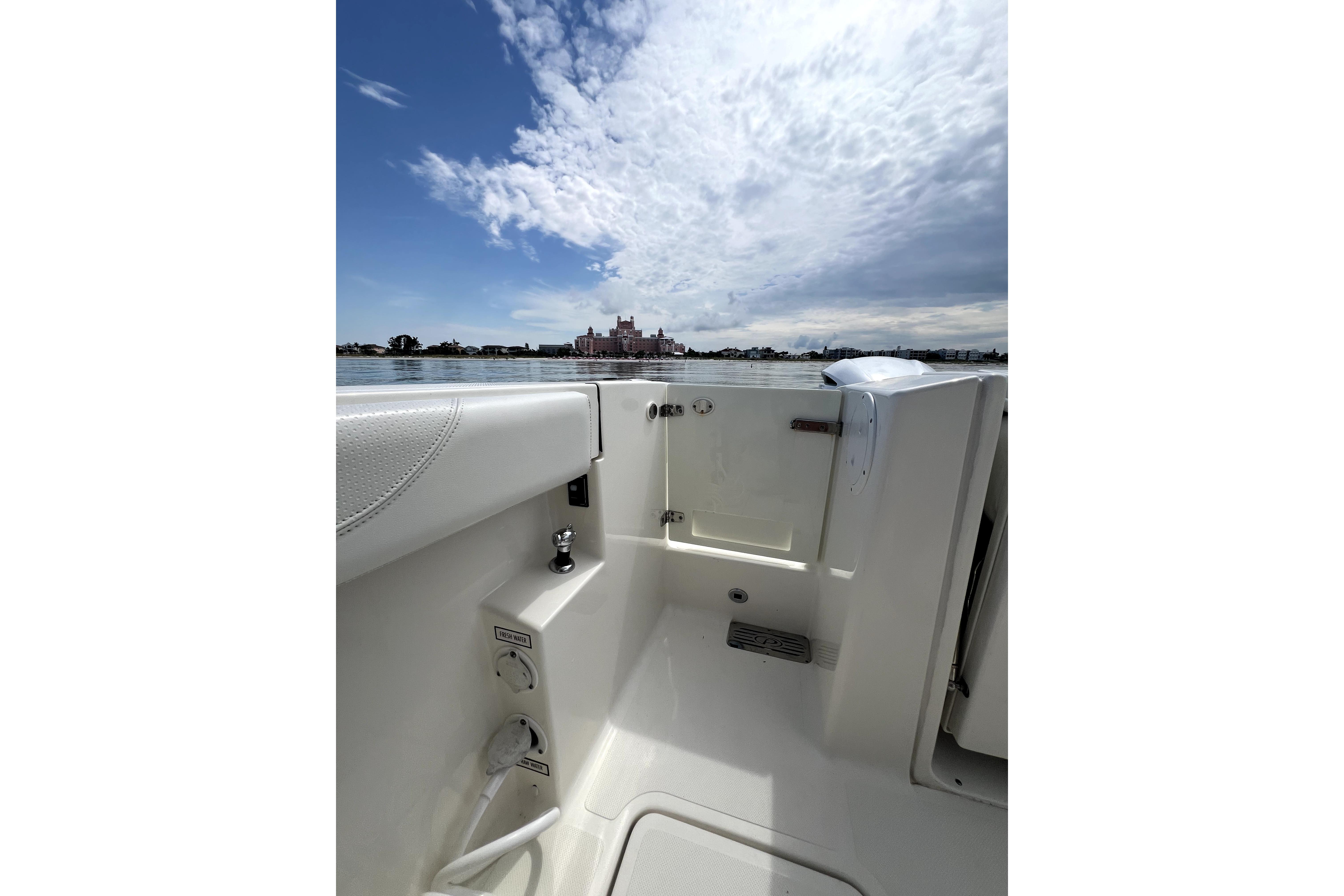 2020 Pursuit S 328 Sport boat interior with ocean view and cloudy sky.