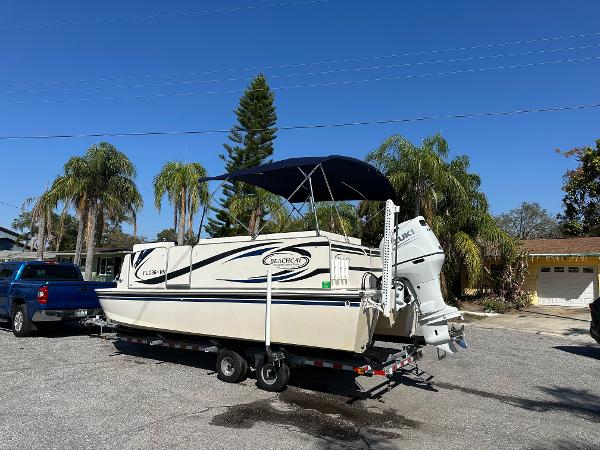 2020 Beachcat 20 boat on trailer, parked outdoors with palm trees in the background.